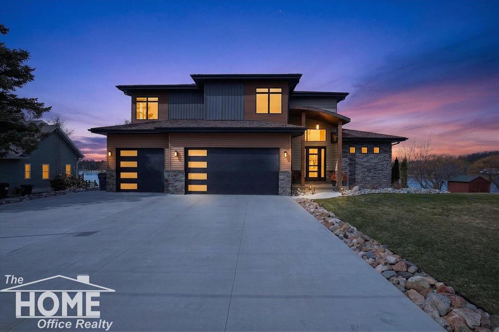 Luxury LAKEFRONT home - back on the market: NO fault of the seller OR the home!  Passed inspections! Passed Appraisal! Buyer couldn't perform!   On Private All-Sports Lake Manitou with 5 bedrooms, 4.5 baths, and 3 car heated garage, plus walkout lower level and theater room for a total of 6,945 finished square ft.  20 ft. ceilings welcome you into the living room with wall of windows overlooking the lake and open to a cook's dream kitchen perfect for entertaining with quartz counters and backsplash, high-end appliances, 2 pot fillers, Pioneer cabinetry, coffee/beverage bar area, and walk-in butler's pantry. 16 ft. sliders open to an expansive deck where one can relax and enjoy the view of the lake. Main level office with view of the lake makes work a pleasure.  Main level primary bedroom suite with one of four fireplaces and ensuite bath featuring quartz counters, walk-in shower with 6 sprayers and rain head shower, soaker tub, and walk-in closet with 2nd washer/dryer and steamer/sanitizer closet.  Upper level hosts a loft, 2 bedrooms with walk-in closets and a Jack n Jill bath, upper-level laundry, and a 2nd private bedroom suite with walk-in closet and ensuite bath. Lower level hosts a 5th bedroom, full bath, fitness room, and expansive great room with pool table, kitchen with island, and walkout to covered patio with outdoor pizza oven, refrigerator, hot tub and TV. Professionally landscaped to the lake with lakeside patio, beach, and aluminum dock.  Lower-level theater room with 14 powered theater chairs and an 8K Ultra Throw projector with 9.1 surround sound system with HD player and concessions room for the ultimate movie experience.  3 car attached garage is heated with water and EV charging station.  Top quality construction with hand crafted details like the copper roof over the entry, and all the extra luxury living touches like robot vacuum system and air diffuser. Automatic whole house generator. On a prime lot in a central location for commuting.  Only 1 1/2 hours to downtown Detroit, Grand Rapids, a