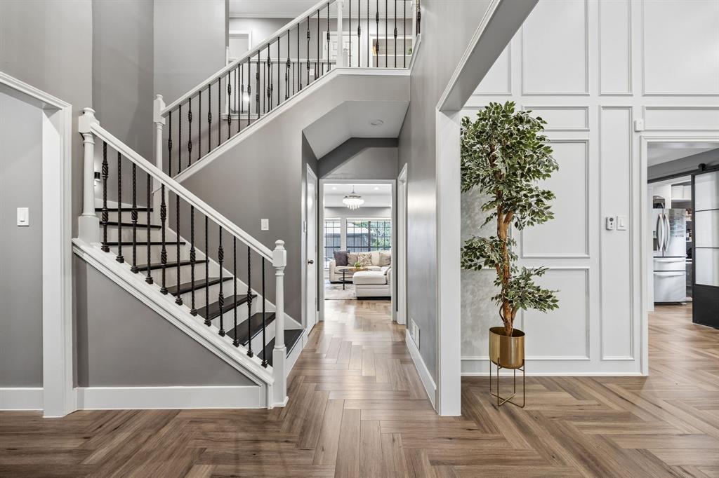 Step into this meticulously reimagined residence. Upon entry, soaring vaulted ceilings and an abundance of natural light highlight the seamless flow of rich wood floors and designer fixtures. Nearby parks, top rates public schools, and choice of excellent private schools too.The chef’s kitchen is a showpiece, featuring custom cabinetry, pristine white quartz countertops, and a striking dark quartz accent island with a gallery sink. Premium stainless steel appliances include a gas cooktop and integrated oven-microwave, while the oversized walk-in pantry—cleverly housing the refrigerator and appliance station, keeps the aesthetic clean and clutter-free. Retreat to a private outdoor oasis featuring a massive pool, expansive decking, and premium turf for year-round, low-maintenance enjoyment. Custom roller shades throughout ensure the perfect balance of light and privacy. A true North Texas gem.