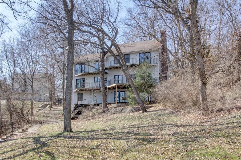 This 5-bedroom, 4-bathroom home sits on 1.84 acres in a quiet inlet of Lake Lotawana, offering stunning lake views from almost every room. With great bones and plenty of space, this property is being offered as is and is a perfect starting point for your dream lake home.

The vaulted living room features wood beams, a fireplace, and an original wet bar, while the kitchen includes multiple ovens, a gas cooktop, and a walk-in pantry. The primary suite boasts lake views, vaulted ceilings, a walk-in closet, and a jacuzzi tub. Generously sized bedrooms allow for flexible living.

Enjoy multi-level decks, a single-well dock, boat lift, shore station, and a large swim dock. A 40x40 insulated garage/shop with multiple garage doors and a loft provides ample storage for cars, boats and more! This home is a fantastic opportunity to create your dream lake retreat! Contact the listing agent for details.