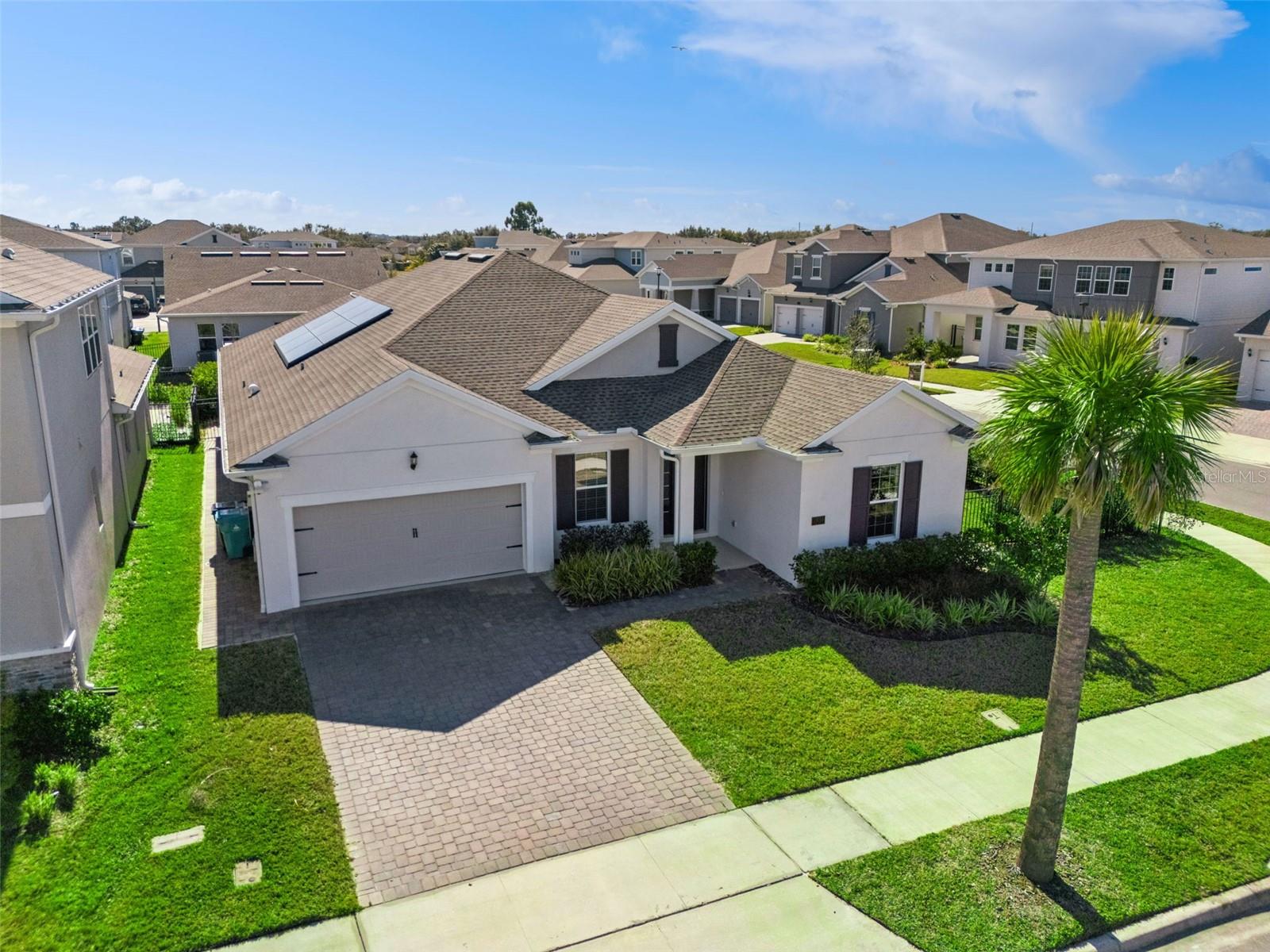 One or more photo(s) has been virtually staged. Welcome to this almost-new, designer-upgraded home in the heart of Lake Nona at 19058 Planetree Street, Orlando, FL 32827 — where modern comfort, smart technology, and luxury finishes come together.Situated on a desirable corner lot, this beautifully appointed residence offers 4 bedrooms, 3 full baths, plus a private office/den, providing flexible space for working from home, guests, or hobbies. From the moment you enter, you’ll notice the thoughtfully selected designer features and durable, stylish luxury vinyl flooring throughout the main living areas.The show-stopping gourmet chef’s kitchen is built for both everyday living and entertaining, featuring a large center island, upscale finishes, and a convenient pot filler, all flowing seamlessly into the open living and dining spaces.Step outside to your private outdoor retreat — a screened lanai designed for true Florida living, featuring a summer kitchen with a Blaze outdoor grill, Italian outdoor porcelain tile, and an oversized jacuzzi/spa, perfect for relaxing evenings and hosting gatherings. The home is further enhanced with WiFi-controlled outdoor lighting for added ambiance, convenience, and security.The spacious primary suite is a true sanctuary, highlighted by a custom built-in closet system for maximum organization. Additional highlights include an inside laundry room with laundry tub and well-sized secondary bedrooms.This home is loaded with modern efficiency and wellness upgrades, including a whole-home water filtration system, Tesla solar panels, and EV charging in the garage, delivering comfort, sustainability, and long-term savings.Located in a wonderful community with walking trails, a community pool, and dock, and just minutes from Medical City and the area’s expanding retail and restaurant destinations, this home offers the perfect blend of lifestyle and location. Besides the community pool the HOA fee also includes internet.Move-in ready and packed with premium features — this is Lake Nona living at its best.