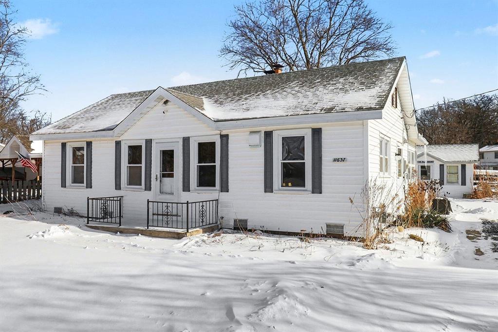Welcome to this inviting Portage Lake home offering sixty feet of water frontage on a huge lot and a half, tucked into a cozy, low-traffic cove with an authentic Up North feel. Located on a quiet cul-de-sac in Hamburg Township, this prime waterfront retreat is just a short boat ride to Portage Lake and provides seamless access to the entire Portage Chain of Lakes. Enjoy the private neighborhood sandy beach at Fox Point Beach directly across the street, featuring a playground and beloved community events like Band at the Beach. This permitted short-term rental is truly turnkey with all furnishings negotiable, making it ideal for immediate personal enjoyment or continued investment use. Inside, the home features two bedrooms, a huge walk-in closet, a charming kitchen with vintage touches and abundant cabinetry. Features include hardwood floors, knotty 3/4-inch red pine, waterproof vinyl flooring, and a cozy wood-burning fireplace with stone surround. An all-season sunroom expands the living space and invites year-round relaxation with two sitting areas and an additional versatile sleeping space. Major updates include a new seawall completed in 2024 by SMP, a Bryant furnace and A/C installed in 2022, an on-demand water heater from 2022, an encapsulated crawl space with AprilAire dehumidifier and two sump pumps completed by FSM in 2018, a new well approximately four years old, a new well pump and pressure tank, a water softener installed in 2025, and a portable generator hookup for peace of mind. Additional highlights include a 200-square-foot outbuilding ideal for storing summer toys or waterfront beach house, a voluntary HOA, and a property survey available, along with unbeatable proximity by land or water to local favorites including Riverside Pizza, Ore Creek Cidery, and NautiMi On The River. This Portage Lake retreat offers the perfect blend of waterfront lifestyle, investment opportunity, and timeless appeal. Move right in and start enjoying lake life.