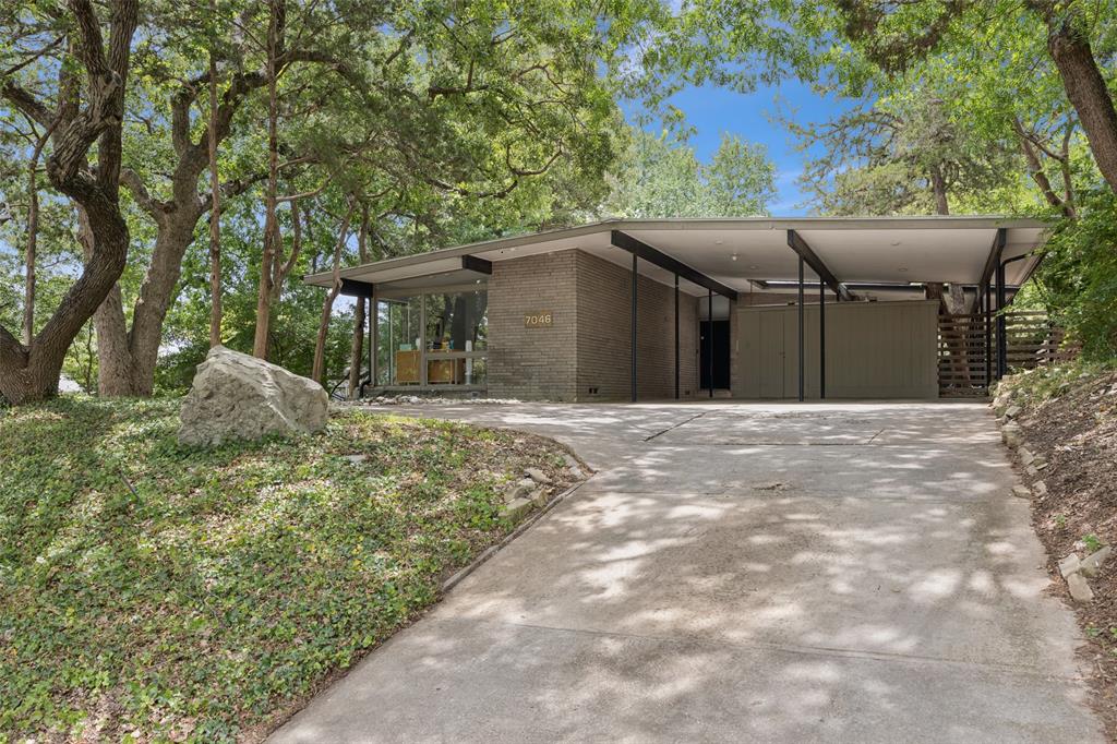 Incredible opportunity to take this midcentury modern gem in Lakewood and make her shine again!  This two bedroom, two bathroom home maintains many of the features that midcentury enthusiasts cherish and is a chance to restore or expand on an oversized lot just steps away from White Rock Lake. The elevated lot offers privacy from the street, and walls of windows open up to a large outdoor living space and the expansive back yard. The open living and dining space, with hardwood floors and a large brick fireplace are bathed in gentle natural light from walls of windows and skylights. A downstairs second living area with soaring ceilings makes a wonderful study, home office, or play room. Each bedroom offers its own full bathroom. No wasted space, and cozy spaces complement wide views with abundant natural light. Exposed beams, low-sloping roofline, open flow, prominent brick fireplace, huge windows, indoor-outdoor living, clean lines, and harmony with the terrain of the property are all here.  The huge lot offers ample room to extend the existing structure without losing the wow factor. Some significant upgrades already completed, including newer HVAC and standing seam metal roof, as well as renderings for proposed addition available upon request.