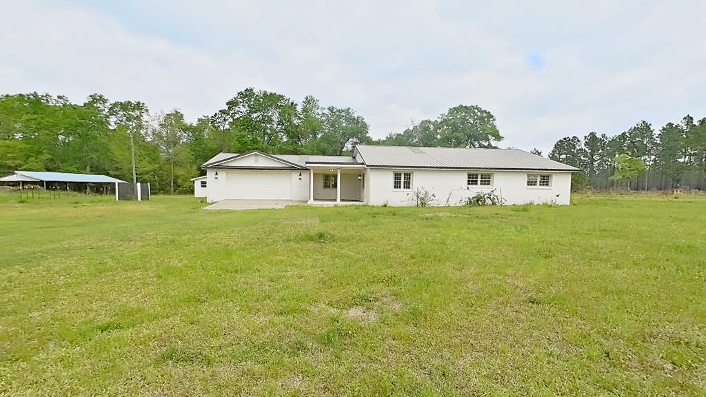 Country living meets modern convenience at 219 Lady Bug Lane in Whigham, GA. This updated 4-bedroom, 2.5-bath home features low-maintenance luxury vinyl plank flooring throughout, generously sized bedrooms, spacious walk-in closets, and double vanities in both full bathrooms.  The bright, open living space creates an inviting atmosphere, complemented by a well-appointed kitchen with updated, smart-enabled appliances including a Bosch dishwasher and electric range. Thoughtfully upgraded for comfort and efficiency, the home also includes a 2022 heat pump HVAC system, tankless electric water heater (2024), updated well pump wiring (Dec 2025), and newer fixtures throughout such as faucets, showerheads, ceiling fans, and lighting.  Situated on 14.53 acres with a new survey completed in 2024, the property includes mature pecan trees, over 100 edible fruit trees and bushes, established strawberry plants, wild blackberries, a shed, and a duck coop with run.  Whether you're dreaming of a mini homestead, a place to spread out, or simply a move-in-ready home with room to grow; this property delivers! Schedule your private showing today and experience the charm of country living in South Georgia!