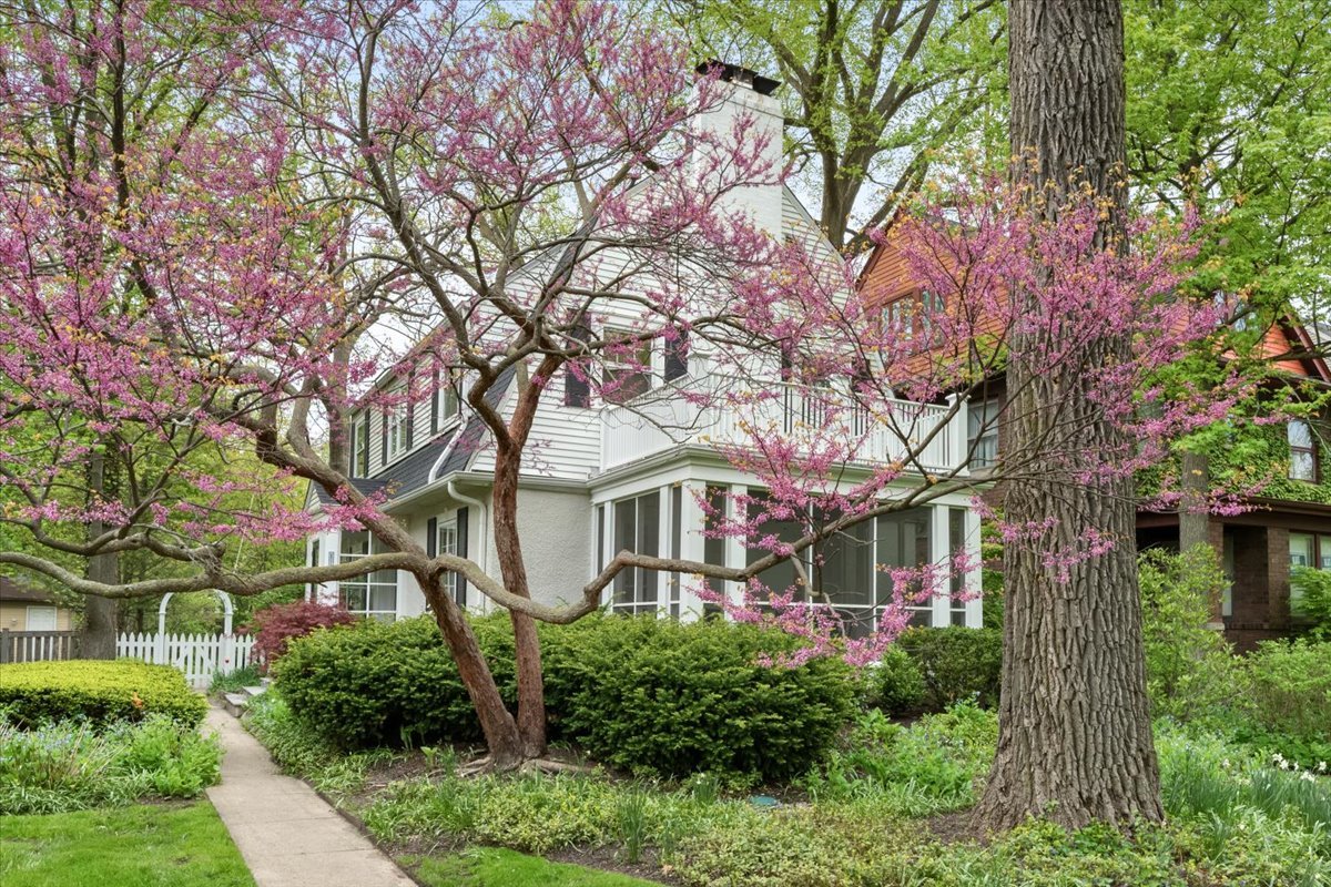 Charming Center-Entry Dutch Colonial on Coveted Park Place  Perfectly situated on sought-after Park Place in Evanston, this picturesque street is known for its wide parkways, sweeping lawns, and mature trees-all just steps from the boutiques, cafes, and dining along Central Street.  Inside, a gracious floor plan blends timeless character with thoughtful modern updates. The spacious living room features classic dentil moldings, recessed lighting, a wood-burning fireplace, and doors opening to a breezy screened porch-perfect for relaxing or entertaining.  The elegant dining room flows seamlessly into a sun-drenched family room, where walls of windows frame views of the beautifully landscaped backyard. The updated eat-in kitchen is both stylish and functional, offering abundant cabinetry, granite countertops, breakfast bar seating, and stainless-steel appliances including a six-burner Wolf range.  Upstairs, the generous primary suite offers three closets and a beautifully renovated en-suite bath. Two additional bedrooms-one currently configured as a home office-share an updated hall bath featuring a stunning walk-in shower and radiant heated floor.  The finished basement provides exceptional flexibility with two separate living areas ideal for a recreation room, playroom, fitness space, or additional office.  Additional highlights include hardwood floors, SpacePak central air, abundant natural light, a large backyard, dog run, two-car garage, and beautiful landscaping both front and back.  Located in Willard School district and moments from neighborhood favorites including Backlot Coffee, Tag's Bakery, Great Harvest Bread Co., Bluestone, and Whole Foods Market, with nearby green spaces including Triangle Park and Independence Park. Convenient access to the nearby Metra station makes commuting effortless.  A perfect blend of charm, character, thoughtful updates, and premier location-love where you live.