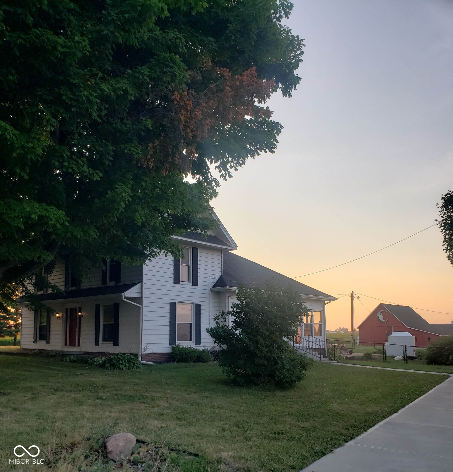 Rare residential and income opportunity. Escape the ordinary and discover this beautifully updated farmhouse set on 2 acres, just 10 minutes from Greenwood. Whether you're dreaming of a serene country lifestyle, an income-producing property, or both - this home offers it all. Currently generating $5,000/month, with two high-performing Airbnb rentals, one of which doubles as a cozy event space hosting birthday parties and gatherings for approximately 35 guests, this property practically pays for itself. Step inside the main home and you'll find: 3 spacious bedrooms & 2 full baths, a loft, two full kitchens and two laundry areas - ideal for extended family or rental flexibility. Newer furnaces and air conditioning systems in both the main home and private Airbnb. Fully furnished and turnkey. Outbuildings galore: large garage, a potting shed draped in fairy lights, children's playhouse, horse stalls, chicken coop, and ample storage and electricity across the property. A pasture with apple trees, cherry tree, wood fired pizza oven, and a community food pantry loved by neighbors. A fully stocked wood shop, Kubota zero-turn mower, and spray tanning studio (included with full-price offer!) along with select furnishings (including all Airbnb setups). This property offers immediate income potential and a chance to create the lifestyle you've always imagined. With space for the owner to occupy as well, whether you envision hosting family, growing a business, tending your garden, or simply soaking in the peaceful country air, this property is ready to make it happen. Location: 10 minutes from Greenwood Income: $5,000+/month potential Bonus: Airbnb furnishings + spray tanning studio + more included. This is more than a home - it's a lifestyle, an investment, and a rare opportunity all in one.
