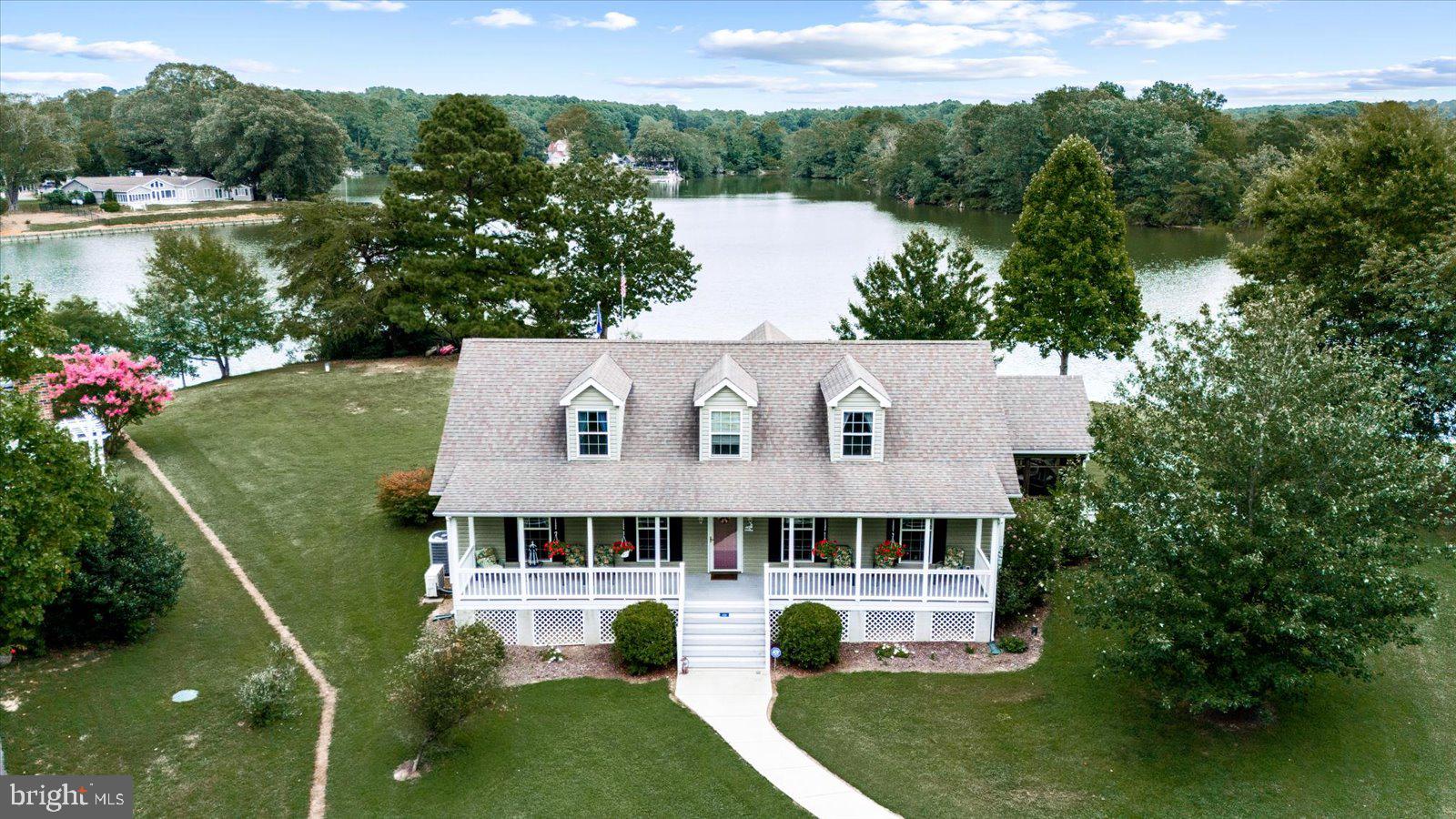 First time offering of this extraordinary homestead located on Whays Creek. The unobstructed views are superb with an impressive panorama of water and colorful skies. The 1.2 acres is perfectly planned for optimal entertaining and use. It has a manicured lawn with shaded areas and is not located in a flood zone. The asphalt driveway leads you to the inviting front porch of this well maintained home. Inside you will find two main level bedrooms and bathrooms with a split bedroom floor plan. Each with plenty of natural light coming into the home. The center hub of the home includes the kitchen, dining, living room and screened porch. These areas offer breathtaking views out to the water. This area is spacious and is great for entertaining. There is a separate laundry room on the main level and the washer and dryer convey. You will enjoy the screened porch year round. The views the views the views...WOW! Head upstairs and you have an overlook to the family room and water. There is a full bedroom and full bathroom and living/game room on the upper level.  Mini split systems installed on upstairs level. There is a 76' Dock with power and a boat lift of 8k lb. Home comes with a generator, gas fireplace and storage shed too. The heated garage is a car lover's dream. Two doors 10X9 doors(one automatic),a lift inside, private electric meter and a full upstairs. This space above the garage can be converted to a living space/game room or used for storage. Don't miss out on this awe inspiring home.