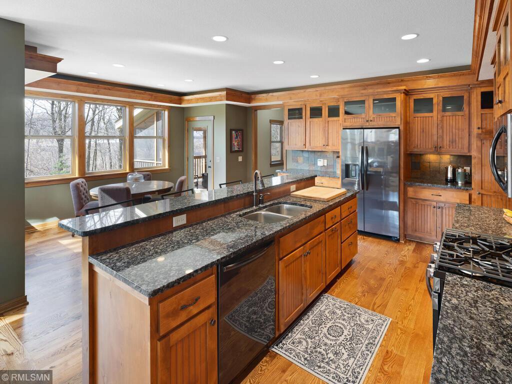 Your very own Sherwood’s Forest getaway. A former Parade of Homes model surrounded by towering pines. Custom mill work throughout, knotty alder cabinetry and 3rd degree white oak floors & molding. Porch stretches across the entire front of the home and screened porch of the back. This home was built for entertaining. A chefs kitchen with new appliances, and its oversized granite island is a perfect gathering place for guests. Lower rec room and wet bar are ideal for entertaining the big game! Or escape to your quiet master suite with a book in your sitting room and custom walk-in closet, whirl pool tub and oversized stone tile shower. Conveniences include mud room with custom lockers from service entrance to kick off your boots and hang your hat and 2nd level laundry. A stunning showcase home. Professional photos to come.