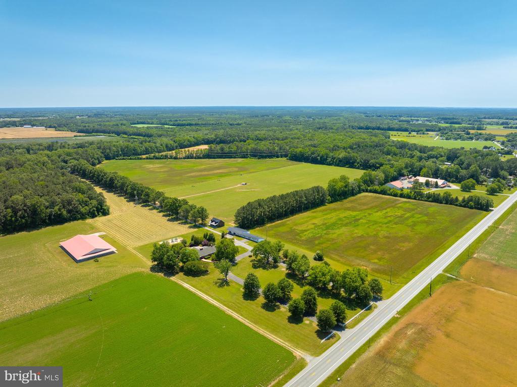 Incredible opportunity to own a 208.17 acre estate across 4 parcels in a desirable rural setting just 5 miles from downtown Salisbury. This unique property offers a balanced mix of 100± acres of cultivated farmland, 8 acres of developed open space, and 100.17 acres of very mature mixed hardwood and pine forestland. Property is ideal for agricultural use, recreation, or long-term investment (see Timber Cruise under Documents). Preliminary percolation tests (see documents tab) indicated very suitable soils for future developments and expanded septic areas. Current farming tenant paying $70 per acre per year and desires to stay.Main Residence:A beautifully updated 3,433 sq ft ranch-style home featuring 4 bedrooms, 2.5 bathrooms, an expansive layout, and quality finishes throughout. Renovations include a custom kitchen remodel, bathroom renovation (2019), new roof (2014), and two 5-ton hybrid HVAC systems (gas & electric). Outdoor amenities include a hardscaped patio, rear porch, composite deck, and in-ground pool—perfect for entertaining and relaxing.Secondary Residence:A separate 2,570 sq ft detached single-family home with 3 bedrooms and 2 bathrooms, plus a 572 sq ft attached two-car garage. Ideal for multi-generational living, guest accommodations, or rental income potential. There is a Commercial Special Exception for a Hair Salon which would likely also permit light professional uses such as CPA's or Counselors.Accessory Structures:10,000 sq ft insulated multi purpose building with conditioned apartment, storage, and a 12’H x 14’W roll-up door.1,800 sq ft two-story custom structure, newly built with high-end finishes, full kitchen, bathroom, gas fireplace, and a hidden bookcase door leading to the second level—an ideal man cave or guest suite.4,900 sq ft building featuring two garage bays, a 1-bedroom apartment with walk-in closet, oversized laundry facility, and additional storage. Fully self-contained with its own well and septic system.This is a rare opportunity to own a turnkey residential farm compound with multiple dwellings and expansive infrastructure, perfect for a working farm, multi-family living, or secluded estate.Schedule your private tour today—this one-of-a-kind property won’t last!