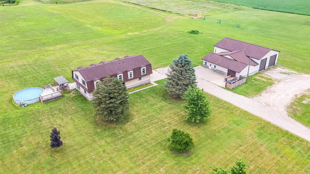 Gearhead's Paradise on Nearly 9 Acres. This isn't just a home, it's the ultimate setup for living, working, and wrenching in style. Welcome to your 5-bed, 3.5-bath country estate, perfectly positioned between Okemos, Lansing, and Brighton. While the interior has been extensively updated with modern touches like three fully remodeled bathrooms, new flooring upstairs, fresh doors, top-quality siding, and a newer roof, it's what's outside that will blow you away. The real showstopper is a massive 72' x 60' outbuilding with everything in place to run a full-time operation or build your dream garage shop. It features: Separate front office/reception area, ready for clients, In-floor heat for comfort year-round, Pellet burner & bathroom plumbing already installed, High ceilings and wide-open workspace, perfect for lifts, detailing, restoration, or storage Whether you're a car enthusiast, small business owner, or serious hobbyist, this setup is turnkey and ready to rev. And when it's time to unwind, take a dip in the 24' pool with attached deck or explore the open land, perfect for riding quads, snowmobiles, or starting your own mini farm. There's room for everything here: animals, gardens, gear, and more. Schedule your private showing today. Please Note: Bar Fridges in Garage are NOT Included, and All Equipment in Outbuilding is NOT Included, but all are Negotiable. Seller Will Install Doors upstairs upon Accepted Offer.