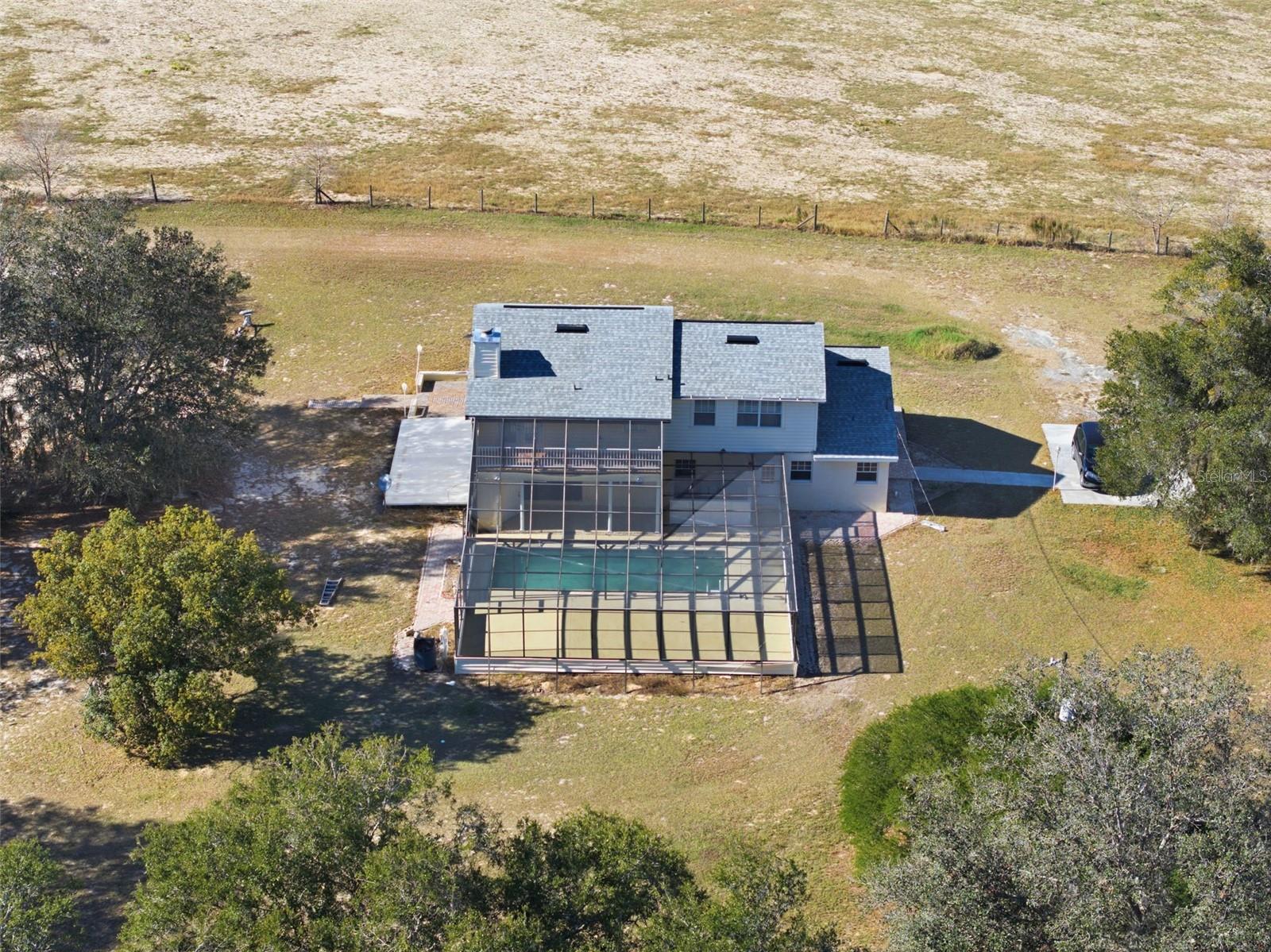 **PRIME LOCATION** 2 STORY POOL HOME with a FULL BASEMENT ON 20 ACRES! Enjoy the High & Dry acreage with rolling hills & valley views! This property offers incredible potential for those ready to bring their vision to life. NEW Roof 1/2025, main level has living room with woodburning fireplace, open kitchen including all appliances, large dining area & a cozy kitchen nook area + one bedroom & half bath. Upstairs features 2 master bedrooms with baths. Basement is 1,246 sq ft with movie room including bose surround sound speakers & media projection TV screen. Home has 2-A/C units. The property offers, two wells, a 1970 (2,970 sq ft) concrete building + 2004 (2,100 sq ft) Horse Barn + Inground Pool with electric heater. The home & property needs TLC. Property sold ''As Is'' cash only.