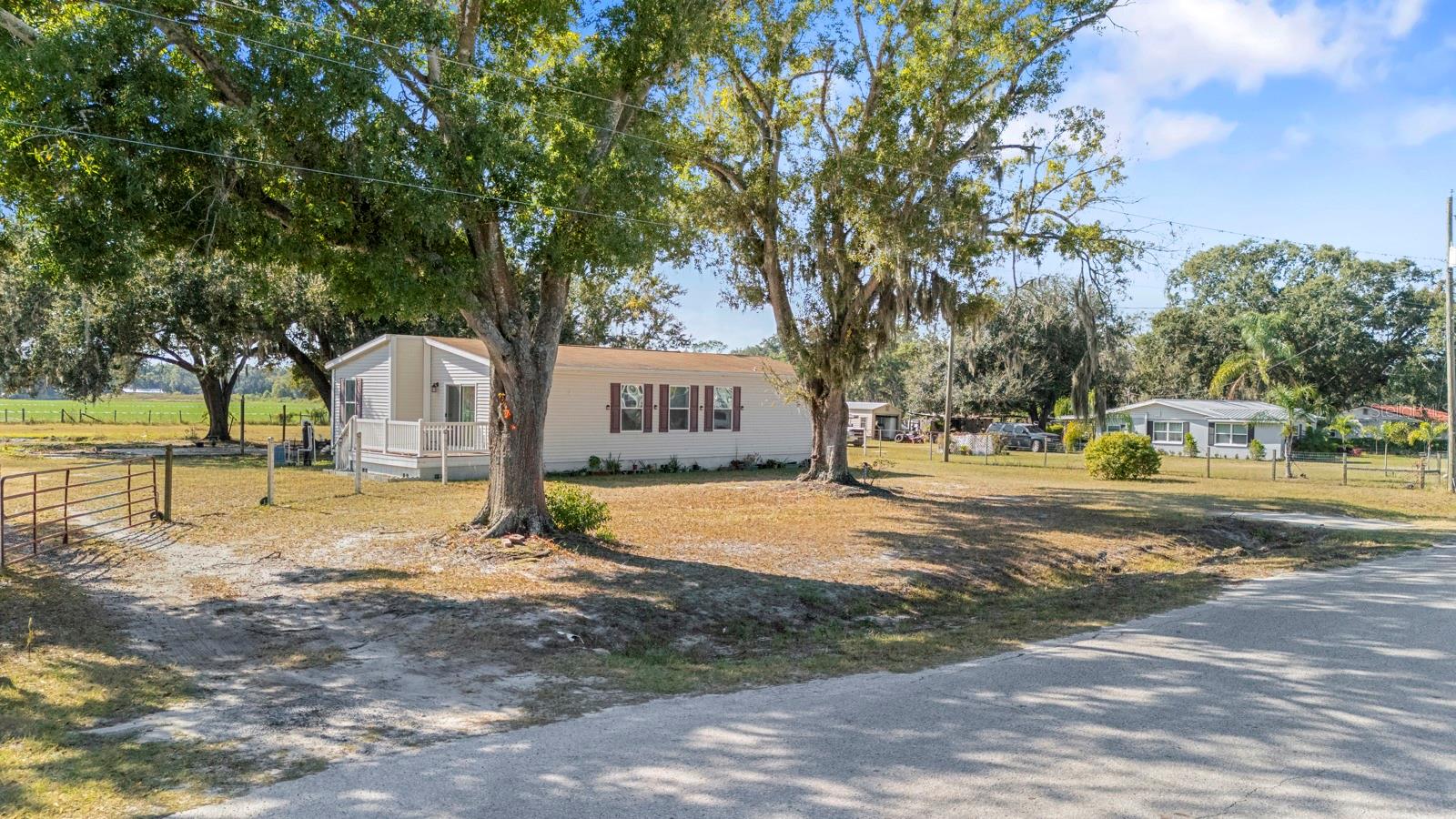Welcome to peaceful country living in Plant City! This charming 2 bedroom, 2 bath home features a flex room that can serve as a 3rd bedroom, office, or den, offering versatility for any lifestyle. The split floor plan provides privacy, while the open kitchen/living room combo creates a warm, inviting space for gatherings. Sitting on just over one acre, this property offers no backyard neighbors, a fully fenced yard, and plenty of room for outdoor living, pets, toys, and more. The roof and A/C are only 5 years old, providing peace of mind for years to come.  Enjoy the serenity of country living while still being just minutes from shopping, restaurants, and conveniences. If you’re looking for space, privacy, and comfort, this is the one!