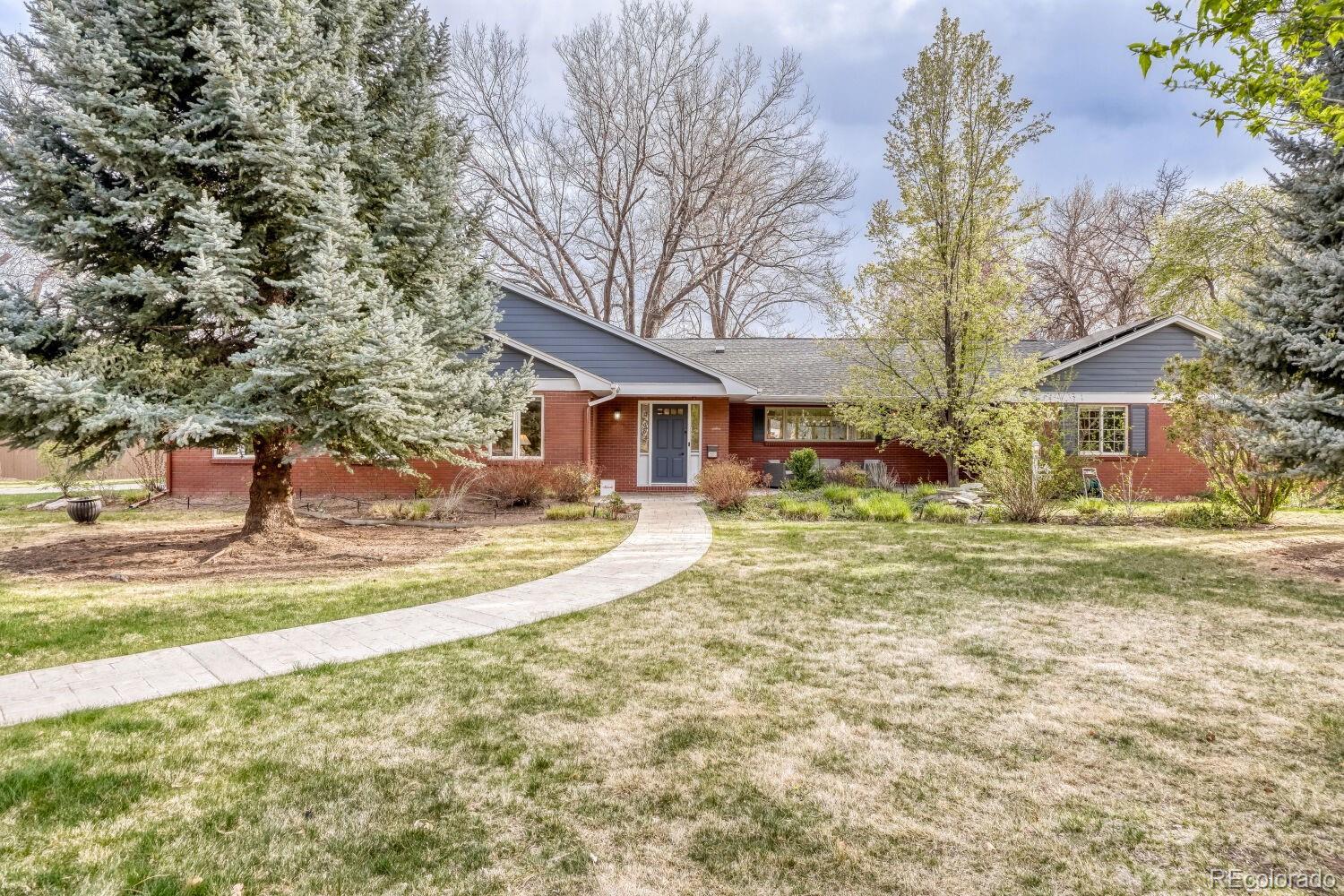 Welcome to 2600 E Eldorado Place—an exceptional Wellshire residence that perfectly blends luxury, functionality and one of the most coveted locations in Denver. Situated on a 16,200 square foot corner lot—an almost unheard-of size in Denver—this home is surrounded by the mature trees and lush landscaping. With incredible yard space there is room to entertain or simply enjoy the peaceful setting. From the moment you step inside, you are greeted by soaring ceilings, beautiful hardwood floors, and walls of windows that absolutely bathe the home in natural light. At the heart of the home is the completely remodeled kitchen with an oversized island, 42-inch shaker cabinetry, stunning finishes, and a full Bosch stainless steel appliance package. The induction cooktop is a chef’s dream—offering precision cooking, easy cleanup, and a surface that stays cool to the touch. There is even an InstaHot system, one of those luxury features you never knew you needed until you have it. The adjoining dining room features panoramic windows overlooking the backyard and even offering glimpses of the mountains. A dramatic double-sided gas fireplace creates a warm, sophisticated focal point between the dining and living rooms. Step outside to the southwest-facing stamped concrete patio—the perfect place to unwind while taking in Colorado’s spectacular sunsets. The primary suite is truly a retreat, with a generous size, a massive walk-in closet, and a beautifully updated five-piece bath. All four bedrooms are oversized with excellent closet space, and every bathroom in the home has been stylishly renovated. Additional highlights include an oversized mudroom/laundry room, a large two-car garage with attic storage above, an EV charger, and 26 owned solar panels that currently pay for all electrical costs. Just 1 block from highly acclaimed Slavens K-8 (ranked 9/10 on GreatSchools), very near the bike path and close to grocery/restaurants makes this home true luxury living without compromise.