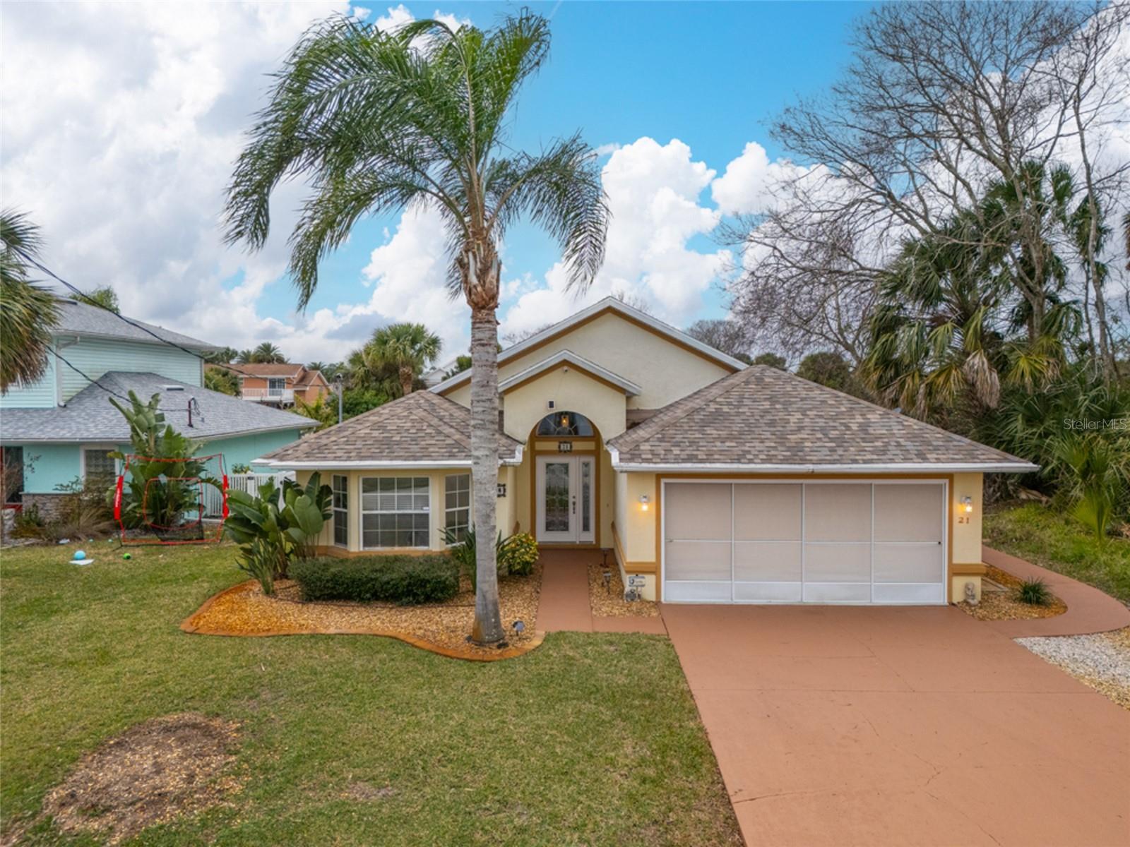 WELCOME TO 21 COMANCHE COURT in the sought after Palm Harbor neighborhood of Palm Coast. DISCOVER this saltwater living paradise home, waiting for you with a spectacular boathouse with lift, and a screened in-ground heated pool. This beautiful 3-bedroom, 2 bathroom canal front home in the City of Palm Coast is the perfect blend of comfort, and outdoor living, enjoy access to the Intracoastal waterway free from bridge obstructions. Overlooking the canal we have the main bedroom, Living room, kitchen nook and pool presenting yourselves with breathtaking water views. In addition this home boasts cathedral ceilings, great room, plant shelves, 2 car garage, screened pool, security system, irrigation well, sprinkler system, ceiling fans and an outdoor shower. HVAC (2022),New Roof (2017) a 12x12 dock with a 20x12 boathouse w/ 1' cantilever walkway (2014) FPL surge protection plan, pool has been rescreened, termite policy in place, tile floor throughout the home, and an exterior storage unit. Just minutes away by boat you'll find the famous Intracoastal waterway, Matanzas river, and the vast Atlantic Ocean. Palm Coast boasts over 150 miles of bike paths, and offering stunning views, excellent restaurants, coffee and pastry shops. THIS BEAUTIFUL SALTWATER CANAL HOME TRULY SPEAKS FOR ITSELF- COME SEE IT IN PERSON.
