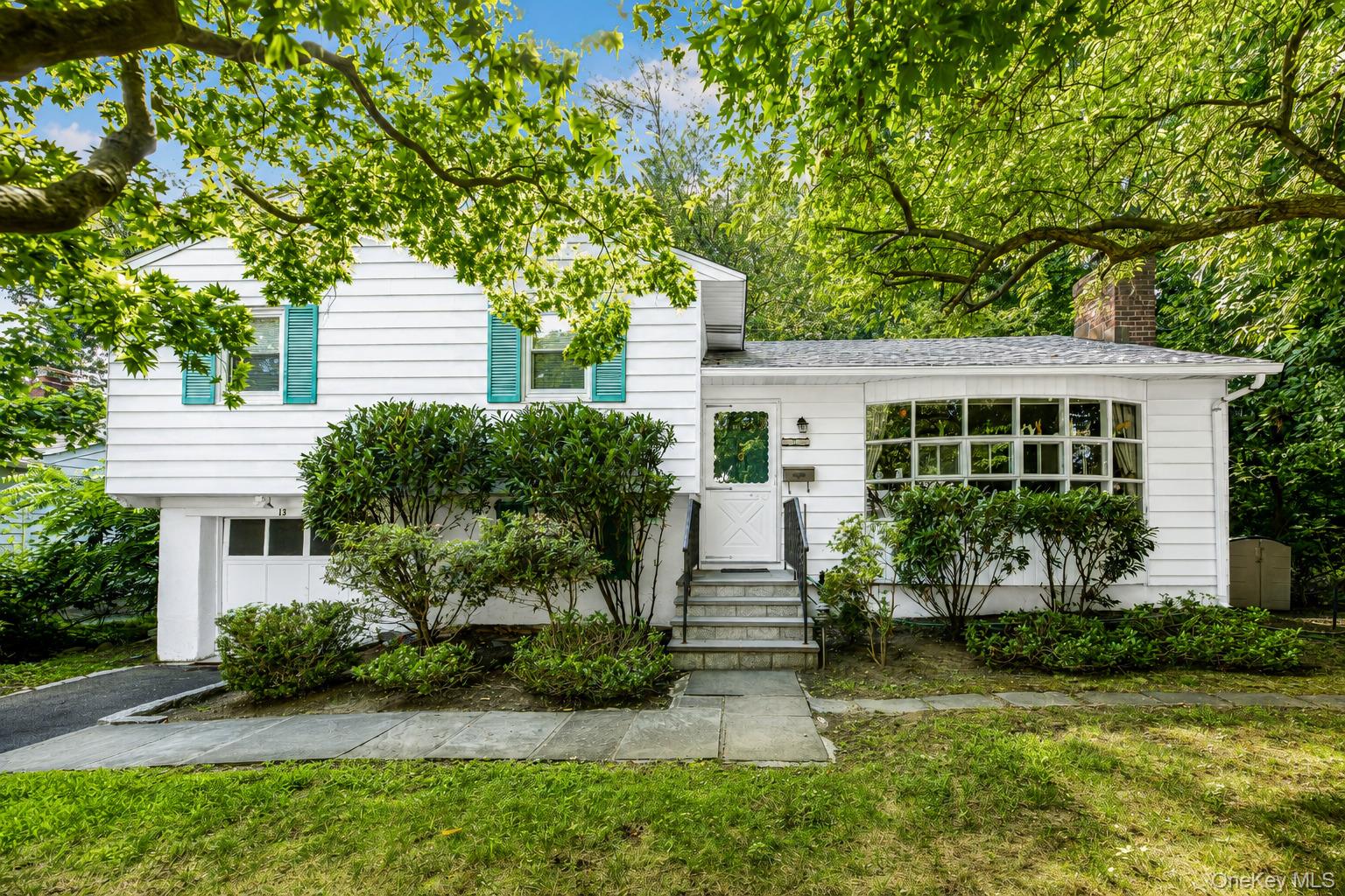 Rare Sanctuary Setting in Nationally Recognized Ardsley School District!Tucked away at the end of a peaceful dead end street, 13 Vista Place offers an extraordinary blend of unrivalled privacy and unbeatable suburban convenience. Backing directly up to lush, mature woods, this home provides a rare, tranquil nature retreat where you will feel worlds away, while still being close everything.Step inside to a sun-drenched living room with expansive windows, flowing seamlessly into the formal dining room. The standout feature of the main living area is the gorgeous sunroom; a serene year-round haven overlooking the quiet woods, which opens to an oversized deck built for effortless outdoor dining and entertaining.The upper level features three bedrooms and a full bathroom. The lower level offers a cozy den with a second full bathroom.  Downstairs, the full finished basement provides bonus space ideal for a recreation room, home gym, or media lounge, complete with dedicated laundry facilities.Situated in the prestigious Ardsley School District with bus pickup right at the bottom of the road, and close proximity to the award winning high school. Enjoy a premier central location minutes to Hartsdale, Scarsdale, Ardsley, and Dobbs Ferry villages, Metro-North train stations (approx. 40 mins to GCT), shopping, dining, and major parkways. Your dream sanctuary awaits!