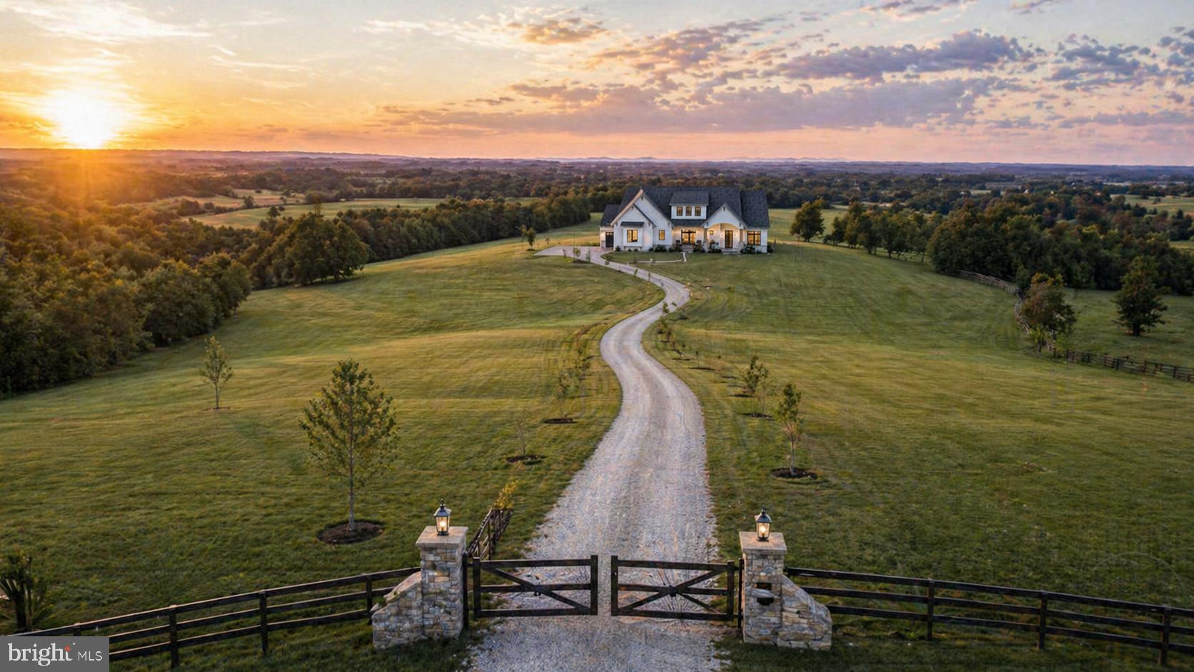 Welcome to Everhill House at Hughsville, a quietly extraordinary offering set across more than 15 acres of gently rolling countryside, where open sky and far-reaching mountain views become part of everyday living. From its first approach, the home presents with a refined architectural presence with textural Hardi siding, graceful arches, and hand-finished wood detailing subtly balancing timeless craftsmanship with a warm, modern sensibility. Inside, the experience unfolds with intention. A gracious entry introduces interiors that feel both elevated and inviting, where each space is thoughtfully placed and beautifully scaled. A private office offers a serene place to work or create, while a main-level guest suite provides comfort and flexibility for hosting. Beyond, the home opens into a light-filled great room anchored by a statement fireplace, seamlessly connected to a chef’s kitchen designed for both function and gathering. Generous in scale, refined in finish, and complemented by an intimate dining area that overlooks the surrounding landscape. The MAIN-LEVEL OWNERS SUITE is a retreat in every sense for peaceful, private, and effortlessly livable, with a spa-inspired bath, expansive wardrobe space, and direct access to the homes everyday conveniences. Upstairs, two additional bedrooms offer their own sense of space and privacy, thoughtfully designed for family or guests. Every element of Everhill House is designed to live as beautifully as it looks: where indoor comfort meets outdoor expanse, and where the land itself becomes an extension of the home. With the option to expand into a substantial lower level, the opportunity exists to further tailor the home to your lifestyle. Whether for entertaining, wellness, or recreation.