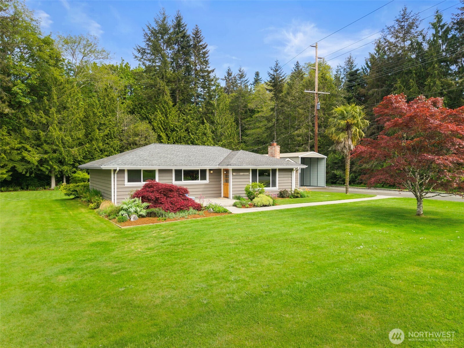 Tucked into the storybook community of Port Gamble, this sweet single-level home blends timeless Pacific Northwest character with modern comfort. Just moments from waterfront shops, restaurants, parks, and playgrounds, this location also offers quick access to the renowned biking and hiking trails of Port Gamble and an easy drive across the Hood Canal Bridge to the Olympic Peninsula. Opportunities to own in this historic community are few and far between.    Custom stamped concrete path & patio welcome you. Inside, the 1,151 sq ft home is filled with warmth and personality featuring 3 bedrooms, 1 bath, original hardwood floors, solid wood doors, and tongue & groove ceilings that honor the home's authentic charm. Large windows and French doors invite in natural light and refreshing coastal breezes, while the mini-split system keeps the home comfortable year-round. You'll find yourself yearning to curl up in the corner by the pellet stove with a page-turner.     Outdoor spaces are designed for enjoying the Pacific Northwest lifestyle with established gardens, expansive back deck, and fire pit perfect for evenings under the stars. The spacious yard yearns to be filled with laughter & games. The detached garage and shop space provide flexibility for hobbies, storage, or projects, plus covered RV parking adds even more convenience. Lovingly maintained and rich with character, this is a truly special home in one of Washington’s most iconic waterfront communities.
