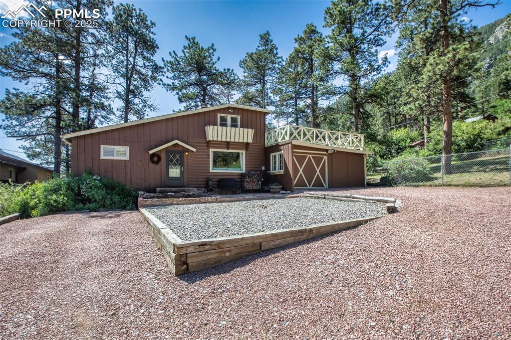 Welcome to your dream retreat or full time residence in Green Mountain Falls, Colorado! This charming home, with lots of character, sits on a peaceful dead-end street. Step into a sunlit living room featuring hardwood floors, rustic log beam ceilings, and a cozy wood-burning fireplace, perfect for chilly mountain evenings. The kitchen has stainless steel appliances (all included!) and flows seamlessly to a fenced backyard with inviting sitting areas—ideal for relaxing or entertaining. Your furry friends or children will adore the spacious yard! The primary suite is a great size, complete with a walkout to a private rear patio. Ample storage throughout with built-in cabinets. Upstairs, discover a versatile space with a wood-burning stove, perfect as an office or additional bedroom, opening to an expansive rear deck with breathtaking views of the surrounding mountains. Furniture is included on the upper level.! Just a short stroll to Green Mountain Falls’ charming gazebo, park, and local restaurants, this home offers the best of small-town living with easy access to nature. Enjoy this private setting while being a quick commute to Woodland Park or Colorado Springs. Don’t miss this rare opportunity to own a mountain gem!