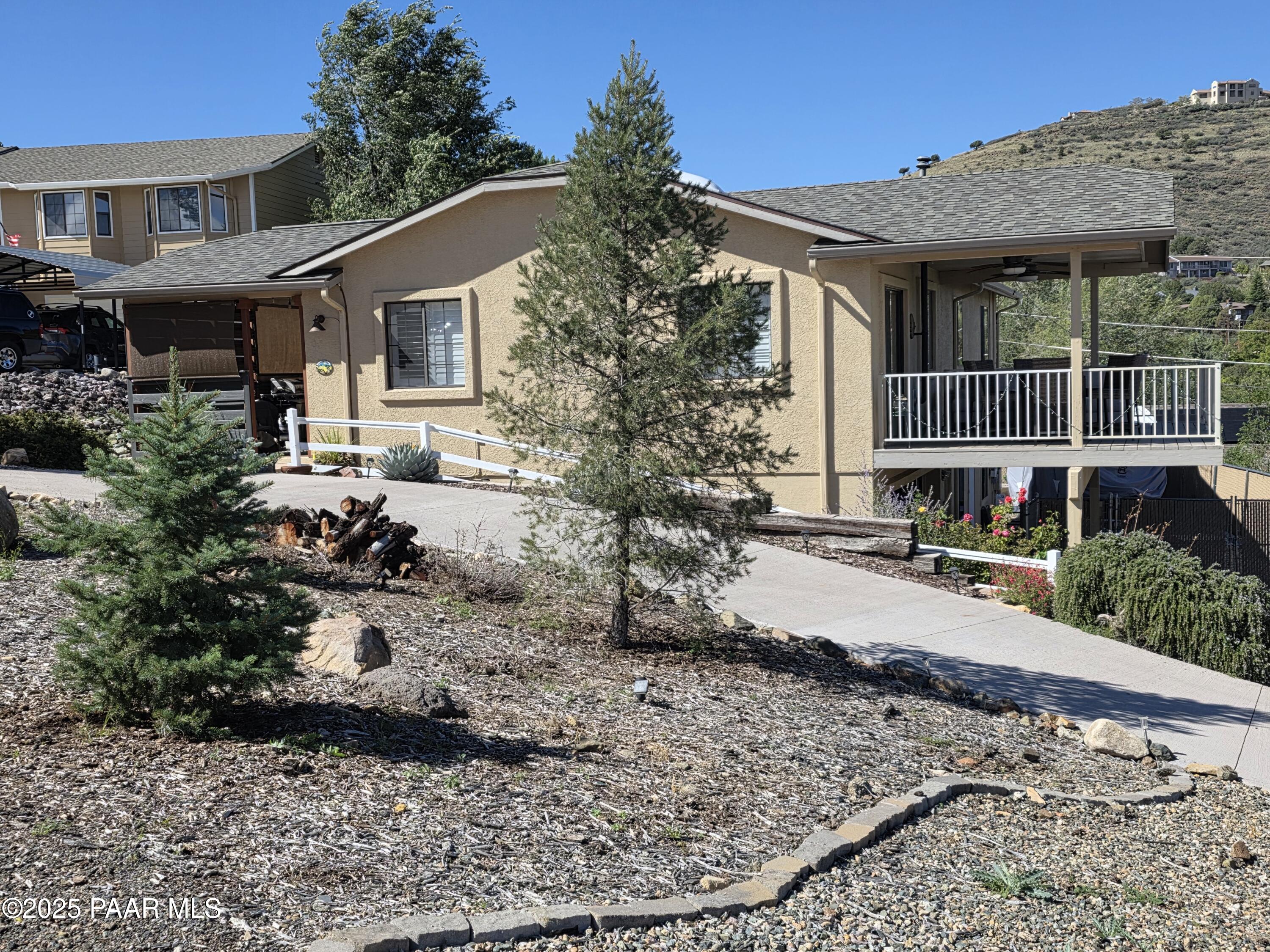 Incredible views, beautifully remodeled, and move-in ready! The main level features 2 bedrooms, 2 baths, new flooring, cabinets, counters, and newer appliances. A fantastic covered deck is perfect for enjoying sunrises and sunsets. The downstairs offers 649 sq. ft. of walk-out space with 1 bathroom, bedroom area, living room, and kitchenette. With its own separate entrance, it's ideal as a mother-in-law apartment or rental. A 20x24 garage provides ample storage, along with a covered front entry, Trex decking, and a nicely landscaped yard with a 5-foot privacy fence. Plenty of room for all your toys!Well Priced! Move In Ready! Easy to Show!