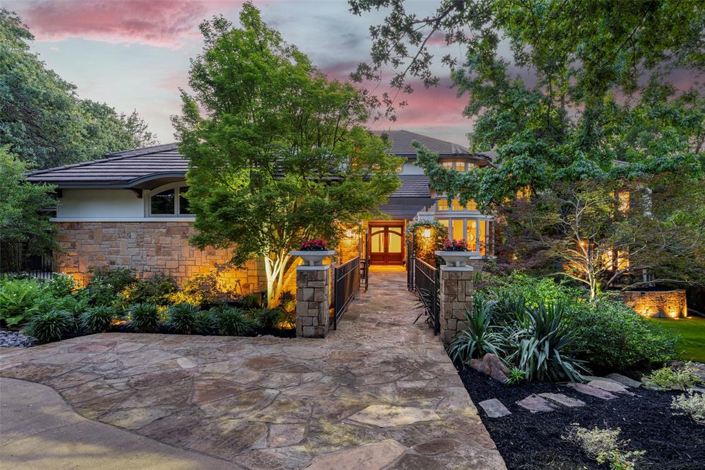 Stunning architecture, refined finishes, and dramatic windows frame spectacular tree-top views of cascading waterfalls and the infinity edge pool in this amazing home. Nestled on a pristine one acre estate, the property offers beautiful grounds, natural woods, and ample patio spaces, for a luxury resort-style feel. Designed for entertaining, the expansive entry leads to the gorgeous dining & living rooms with mahogany floors. Porcelain tiled gourmet kitchen with two islands, butler’s pantry, wine room and sun room with custom mahogany cabinets and trim. Beautifully appointed guest suite completes the main level. Upstairs includes game room with exotic wood touches, magnificent media room; luxurious primary suite with exercise room and sauna. Two other bedrooms include ensuite baths. Weather hosting in grand style or retreating in absolute serenity, this extraordinary home delivers an unparalleled living experience.
