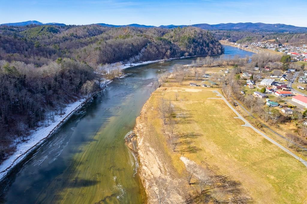 Opportunity to own nearly 2 acres of prime riverfront property on the New River! Nestled in the charming town of Fries, these beautiful lots offer direct water access and are located just steps from the renowned New River Trail State Park. Imagine waking up to the soothing sounds of flowing water and spending your afternoons fishing for smallmouth bass, kayaking, or tubing right from your own property. This location is a recreation lover's paradise, offering miles of scenic hiking, biking, and horseback riding along the New River Trail. Whether you are looking for a peaceful sanctuary to watch the eagles soar or a high-energy basecamp for endless outdoor adventures, this property delivers the ultimate Blue Ridge lifestyle where the river meets the trail. Come check it out today!