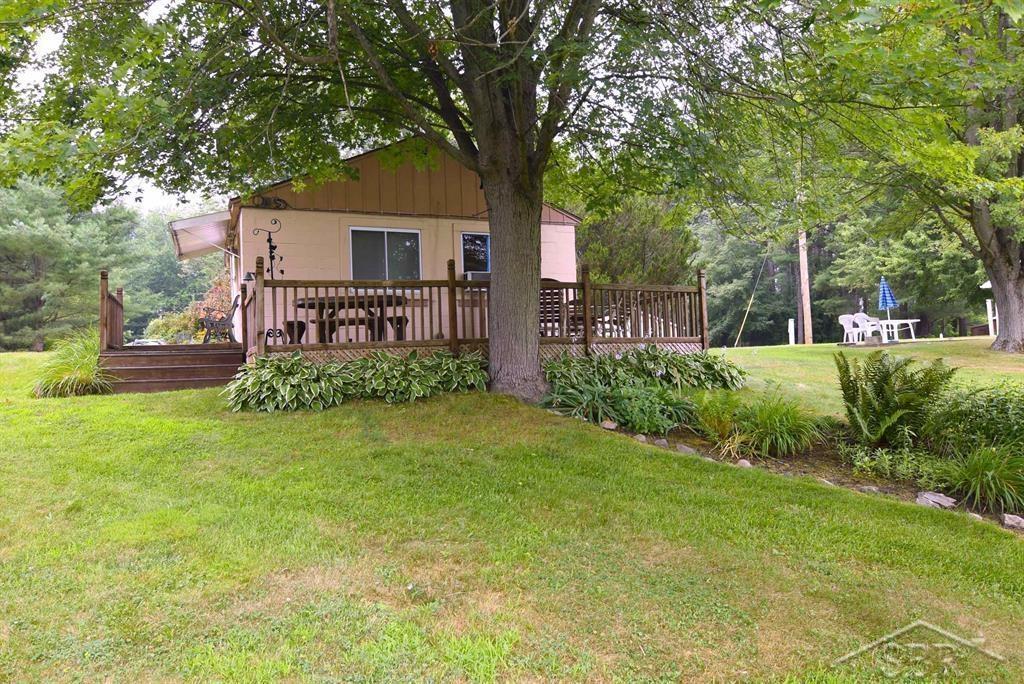 Adorable and solid, this 2-bedroom getaway is ready for life on the water once Wixom Lake returns! Built from durable cinder blocks, this cozy home offers long-term peace of mind with a charming, low-maintenance exterior. Step outside to enjoy a spacious deck-perfect for morning coffee or sunset views-and a steel seawall with an additional deck right at the water's edge. The newer well adds convenience, while a large shed provides extra storage for all your lake toys and tools. Whether you're looking for a weekend retreat or a simple year-round residence, this property is packed with potential!