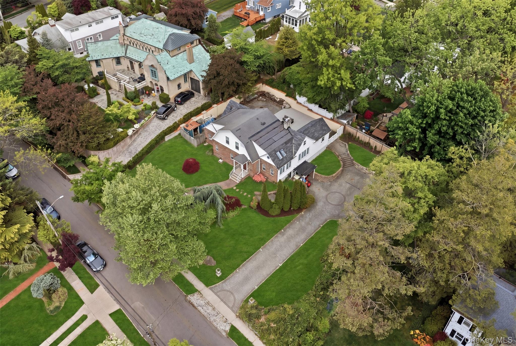 Experience the pinnacle of North Shore living in the exclusive Douglas Manor enclave. This showcase detached Cape sits on an expansive, oversized park-like property, offering a rare blend of suburban tranquility and sophisticated luxury.The ResidenceThis meticulously maintained home is designed for both grand entertaining and comfortable daily living. Key features include:Spacious Layout: 4 generously sized bedrooms and 4 full bathrooms.Main Floor: A welcoming living room, formal dining room perfect for gatherings, and an updated Eat-in Kitchen.Outdoor Living: A luxury outdoor deck and porch provide the perfect backdrop for al fresco dining, overlooking lush, manicured grounds.Finishing Touches: A unique bamboo-lined driveway leads to the residence, and a full finished basement offers versatile space for a home gym, media room, or guest suite.Exceptional Property & Community AmenitiesThe true crown jewel of this offering is the massive 121' x 121' lot. Positioned in a high-demand area, this oversized property presents a premier opportunity to enjoy a massive private estate or capitalize on the potential to build a large luxury home.Living at 319 38th Road also grants access to the prestigious community's private amenities. For approximately $900/year, the HOA provides:Security: Dedicated security patrol.Recreation: Access to a private park and private dock etc.
