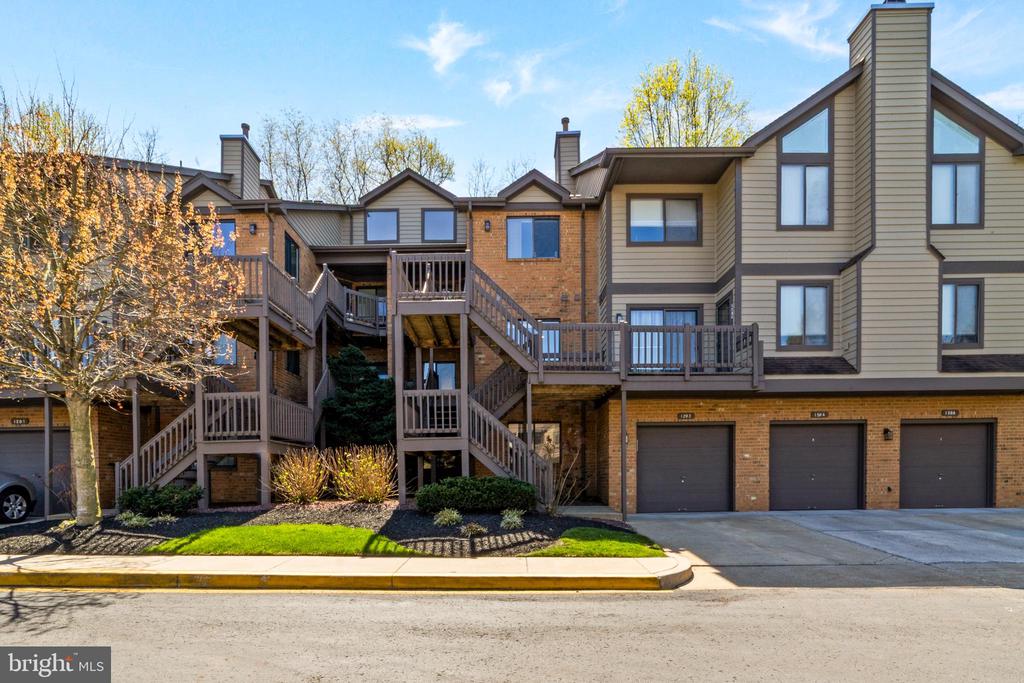 Nestled in the desirable Eagle Point community and adjacent to Ramblewood Country Club, this beautifully maintained townhome offers a serene, park-like setting with peaceful wooded views and exceptional privacy. This 2-bedroom, 2-full-bathroom home makes wonderful use of space, with the bedrooms and laundry on the main level, as well as both full baths. The kitchen, remodeled in 2013, features stainless steel Frigidaire Gallery Series appliances, including a built-in microwave, electric self-cleaning range, dishwasher, and refrigerator, along with granite countertops, a slate tile backsplash, and 42” cherry wood cabinetry. The spacious open-concept dining/living/great room is filled with natural light from skylights and features a cozy gas fireplace.  Double sliding doors lead to a private patio backing to a tranquil green space and woods. The primary suite features its own private bath with a stall shower, a very large linen closet, two large closets, and direct patio access via sliding glass doors, creating a peaceful retreat. A second bedroom on the main level also enjoys private outdoor access. The lower level provides flexible living space, ideal for a potential third bedroom, as well as a separate den or home office. Additional highlights include an attached garage with direct interior access, including a crawl space. The HOA includes sewer and water. Residents can enjoy discounted access to Ramblewood Country Club amenities, including swimming and tennis. Conveniently located just minutes from Interstate 295 and Moorestown Mall, this home offers easy access to shopping, dining, and commuting routes. There’s truly nothing to do but move right in. Schedule your private tour today.