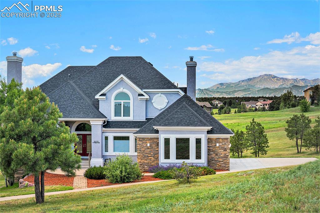 Nestled in the prestigious King's Deer Highlands, this stunning home offers a perfect blend of luxury, privacy, and breathtaking views of Pikes Peak. A long driveway leads to a stately residence, set back on a 2.5-acre lot for added seclusion but elevated for splendid views. The grand entry features a dramatic, curved staircase and elegant slate floors. The formal living room has soaring vaulted ceilings, real wood floors, and a cozy fireplace. The kitchen is a chef's dream, equipped with a commercial-grade gas double-oven, infrared warming lights, Sub-Zero fridge, granite counters, butcher block island, custom cabinetry, and fabulous views of Pikes Peak.

 The adjacent great room features a real-wood fireplace, wet bar with custom-built shelving, and a walkout to a covered deck that offers panoramic mountain views. Upstairs, the master suite boasts a 5-piece bath and enormous walk-in closet with custom-built-ins.  Two additional bedrooms share a Jack-and-Jill bath, and a fourth bedroom with attached ¾ bath on the main level offers versatility.

 The unfinished walk-out basement has 9-foot ceilings and offers endless possibilities for future expansion. The home also features a 3-car garage for ample storage space. The property is lined with mature pine trees and extends to Roller Coaster Road, ensuring no obstructed views. The property is located in the highly-rated D-38 and less than 1 mile from the neighborhood elementary school.  Easy access to King’s Deer walking trails and golf.  This regal estate combines unparalleled views, opulence, functionality, seclusion and convenience, making it an ideal retreat in King's Deer.