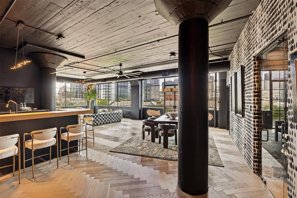 Set within a historic 1920s mattress factory, this architecturally reimagined loft blends authentic industrial character with refined modern European design. Tall ceilings and expansive windows create a dramatic, light-filled living space, anchored by a custom European Poggenpohl kitchen, including a 6 ft. dual-faucet, Galley sink, and a striking 300-bottle glass wine gallery designed for entertaining and display. The residence features 2 large bedrooms, 2.5 bath, large flexible living space, designer kitchen, spa-inspired bathrooms with double vanities, LED-lit mirrors, custom lighting, and a dual shower with soaking tub, while integrated Samsung Frame TVs create a gallery-style living experience, seamlessly blending technology with the home’s architectural aesthetic. With two secure underground parking spaces and walkable access to the Farmers Market, close to entertainment, arts, and the financial district, this is a rare turnkey offering delivering design, lifestyle, and convenience in Dallas’ fastest-evolving district.