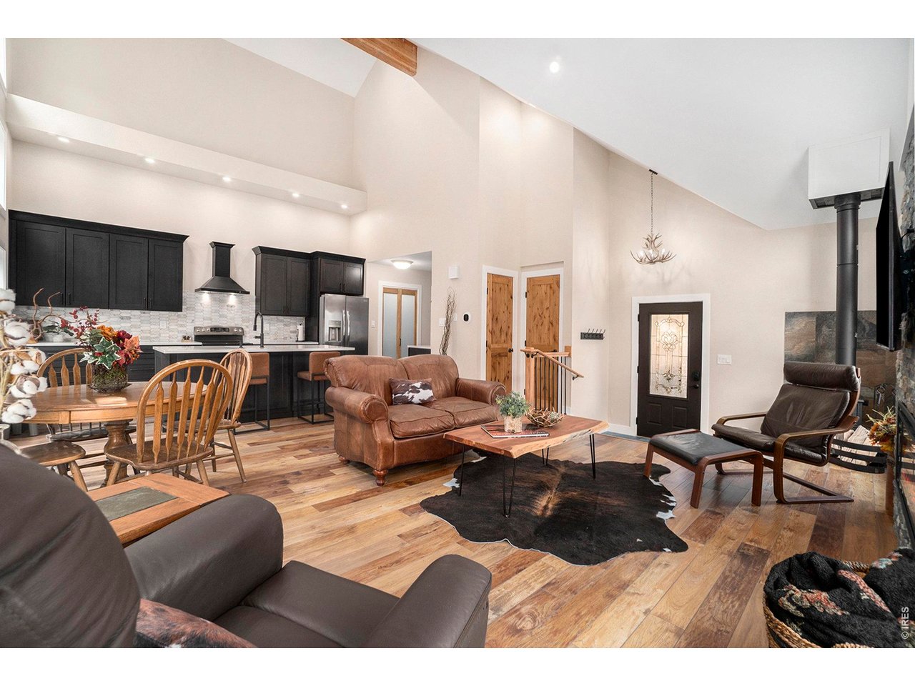 Escape to your own private mountain retreat just 3.8 miles from downtown Estes Park. Nestled on 4.9 acres bordering National Forest and the Big Thompson River, this beautifully renovated property is a dream for outdoor enthusiasts seeking adventure, exploration, and relaxation. The main home has been completely updated and features vaulted ceilings, wood-burning stove, and an easy-to-use electric fireplace that creates year-round ambiance. The sun-filled kitchen boasts new cabinetry, quartz countertops, a large center island, spacious pantry, and beverage center with cooler, while overlooking whispering pine trees and the shimmer of the river below. Outside enjoy the great outdoors or relax on the deck where you can enjoy morning coffee, summer BBQ's or an evening around the fire under the stars. Inside, retreat to the spacious primary suite offering vaulted ceilings, skylights, a private ensuite bathroom with walk-in shower, convenient laundry closet, and a versatile loft area ideal for a home office or flex space. Recent improvements include energy-efficient double-pane windows, durable luxury vinyl flooring, new carpet in the upper-level bedrooms, updated bathroom vanity and lighting, a new roof, and fresh interior and exterior paint. Adding to the property's charm is a separate 340 square-foot rustic cabin. This bonus structure provides flexible space for a guest retreat, studio, hobby room, home office, or peaceful getaway. Whether you're enjoying the fresh mountain air, hiking directly into National Forest, casting a line in the river, spotting local wildlife, or simply relaxing, this exceptional property offers the perfect blend of modern comfort and Colorado mountain living. Create lasting memories with family and friends in a setting where adventure begins right outside your door.