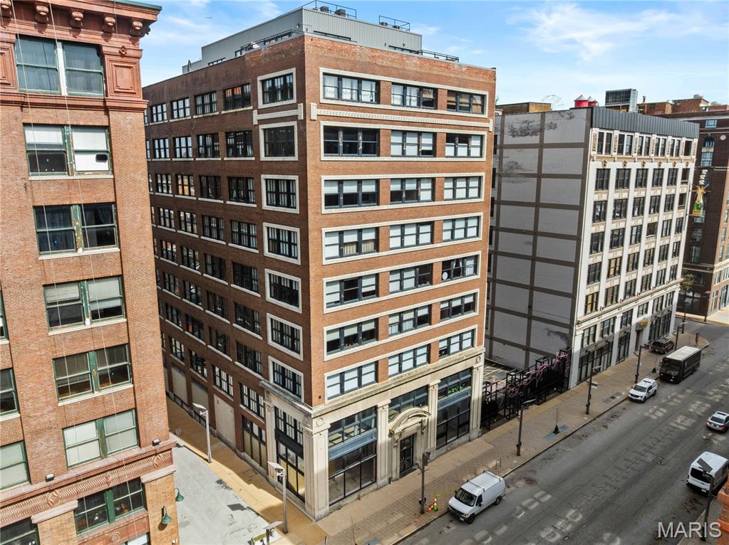 Experience a thoughtful blend of industrial style and everyday comfort in this light-filled Railway Lofts condo. Soaring ceilings and an open-concept floor plan create a spacious, airy feel, while oversized warehouse windows bring in abundant natural light. The kitchen is both functional and refined, with granite countertops, a center island, a gas range, and generous storage (an uncommon feature in loft living). The living and dining areas are seamlessly connected and anchored by a gas fireplace. The primary suite features a custom walk-in closet and a bath with a soaking tub, a separate shower, and an updated vanity. A second bedroom provides flexibility for guests or a home office, with a full bath nearby. Additional features include in-unit laundry, same-floor storage, and garage parking. Ideally located downtown near City Museum, CITYPARK, and the NGA campus, with easy access to SLU, WashU, and top dining spots.