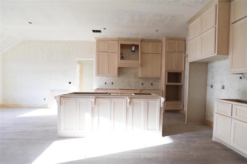 This Hummingbird Bonus Room 1 floor plan includes 2,495 Sqft of total living space, which includes 2,250 Sqft of indoor living and 245 Sqft of outdoor living space. This home offers 4 bedrooms, 3 full bathrooms, a utility room, a bonus room, and a 3-car garage with an in-ground storm shelter installed. The great room embraces a gas fireplace with a stacked stone detail, large windows, wood-look tile, Cat6 wiring, rocker switches throughout, and a flawless cathedral ceiling with a ceiling fan. The up-scale kitchen has stainless-steel appliances including a 5-burner cooktop, decorative tile backsplash, 3 CM countertops, a large center island with a trash can pullout, stellar pendant lighting, well-crafted cabinets to the ceiling with under cabinet lighting and cabinet hardware installed throughout, and a separate walk-in pantry. The prime suite boasts a sloped ceiling detail with a ceiling fan, windows, and our cozy carpet finish. The prime bath supports a dual sink vanity with framed mirrors and 3 CM countertops, a walk-in shower, a free-standing tub and TWO walk-in closets. Secondary bedrooms feature high ceilings with a ceiling fan, windows, sizeable closets, and carpeted flooring. The covered back patio includes an outdoor wood-burning fireplace, a gas line, and a TV hookup. Other amenities include our healthy home technology, an air filtration system, a tankless heater, R44 insulation, and more!