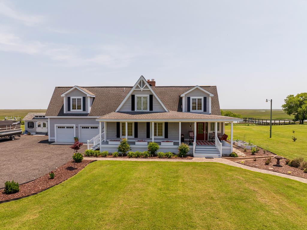 Beautiful inside and out.  Spacious open floorplan and updated contemporary WATERFRONT home on the seaside with moderate water depth channel (approximately 8-9 ft at high tide, 3-4 ft at low tide) with dock.  3 storage buildings, Large front porch, large back deck, hot tub, raised gardening beds, beautifully landscaped, spectacular views and more.  Enjoy a great view of the rocket launches from NASA and the beautiful sunrises. Public boat ramp just down the road for launching a boat.  This property has so many amenities, it's a must see.  Call me today for a showing.