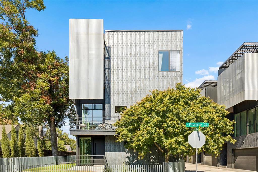 Designed by AIA award-winning architect Josh Nimmo, this architecturally significant, fully detached corner residence at Caxton Court is a three-level modern standout—with no HOA. Thoughtfully designed to maximize natural light and privacy, the home features striking vertical brick detailing, an open yet functional floor plan, and expansive floor-to-ceiling windows throughout. Clean-lined modern finishes include 10-foot ceilings, floating steel staircases, concrete and white oak hardwood floors with a rich coffee stain, and sleek quartz surfaces. The waterfall-edge kitchen is both beautiful and functional, outfitted with Bosch stainless appliances and ample storage. All three bedrooms feature en-suite white quartz baths, creating a true private-suite experience. Additional highlights include a fenced outdoor yard, a high-ceiling two-car attached garage, and custom window shades throughout. This is a rare opportunity to own a modern, architect-driven single family home in one of Dallas’ most desirable in-town locations.