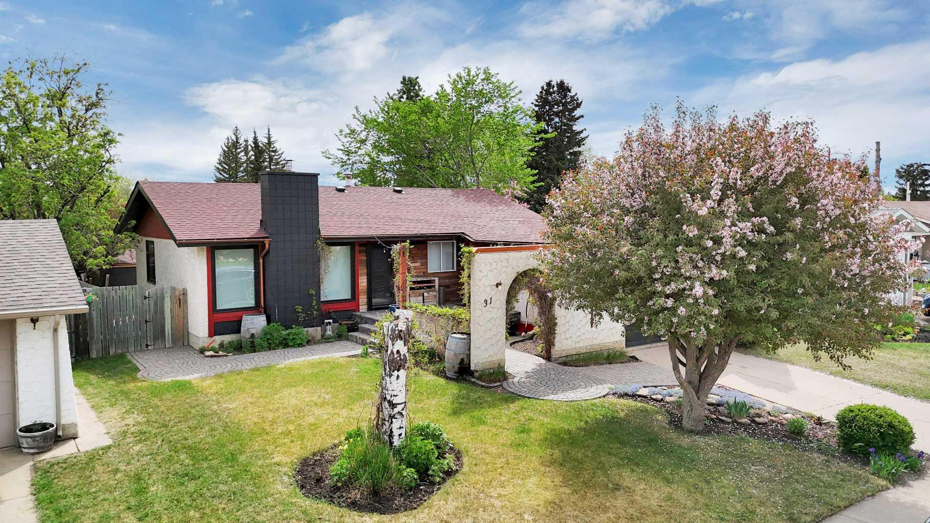 CUSTOM RENOVATION | PRIME MORRISROE LOCATION | PRIVATE LANDSCAPED YARD ~ This beautifully updated Morrisroe bungalow offers the rare combination of modern renovation work, mature landscaping, and one of Red Deer’s most walkable family neighbourhoods. Surrounded by schools, parks, walking trails, shopping, and recreation, you’re just minutes from the Collicutt Centre, Eastview IGA, and multiple schools kids can easily walk to. ~ The main floor underwent an extensive renovation in 2023 including new drywall, new windows throughout most of the upper level, vinyl plank flooring, high-end remote blinds, updated lighting, and a stunning custom kitchen featuring a large island, quartz countertops, brass fixtures, and excellent workspace for everyday living or entertaining. ~ The spacious living room is anchored by a 2023 Osburn wood-burning fireplace with fan, adding both warmth and character to the space. ~ One of the standout features of the home is the oversized front mudroom, thoughtfully designed with extensive built-in storage and a custom pull-out pantry — an incredibly functional upgrade rarely found in homes of this era. ~ The main floor includes 2 bedrooms, a full bathroom, and a convenient 2-piece ensuite off the primary bedroom. ~ Downstairs features BRAND NEW CARPET and fresh paint, along with a large family / recreation area, spacious third bedroom, 3-piece bathroom, laundry space, and potential for a future fourth bedroom. ~ Additional updates include shingles in 2017 and a new hot water tank in 2025. ~ Outside, the sellers have invested heavily into creating a private outdoor retreat with mature trees, stone patio work, raised garden beds, fire pit area, deck space, and beautifully maintained green space. The rear horizontal fence includes a 16 ft gate off the tee alley, allowing future RV parking potential if desired. There is also rough-in on the south side for 220V hot tub wiring or RV plug-in capability. At the front of the property, a decorative pond feature remains in place with liner intact for anyone wanting to restore the water feature. ~ A truly unique property offering modern updates, standout functionality, and a yard and location that are difficult to replicate.