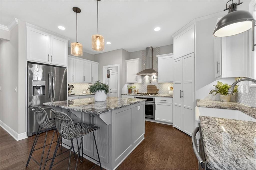 There’s something special about a home that feels warm the moment you walk through the door—and this custom-built 2-story by King Building does exactly that. Nestled in the heart of Creekmoor’s beautiful golf community, this 5-bedroom, 3 full & 2 half bath home is where timeless design meets the kind of everyday comfort that makes life feel just a little sweeter.Sunlight pours through a stunning wall of windows, filling the home w/warmth & highlighting the beautiful hardwood floors, inviting living spaces, & the gorgeous stacked-stone fireplace w/custom built-ins. Just off the main living area, the dining room creates the perfect setting for holidays, celebrations, & gatherings with the people who matter most.At the center of the home is a kitchen designed to bring everyone together. From the large island w/custom granite countertops to the pot filler, abundant custom cabinetry, expansive counter space, & walk-in pantry, every detail was thoughtfully designed for both hosting & everyday living. Just off the kitchen, the mudroom adds the kind of function every busy household appreciates. Upstairs, you’ll find generously sized bedrooms w/walk-in closets, a beautifully designed laundry room w/custom cabinets & a folding table, & the primary suite that feels like a true retreat at the end of the day. With hardwood floors, a spa-inspired bathroom, a freestanding soaking tub, & oversized his-and-her walk-in closets, this space was made for rest, comfort, & a little everyday luxury.The finished lower level offers even more room to live & grow, featuring a cozy fireplace, bar area, 5th bedroom, flex room, & plenty of storage space; making it ideal for guests, entertaining, hobbies, or creating the extra space your lifestyle needs. Outside, the large fenced backyard & covered patio invite quiet mornings, evening conversations, backyard play, & effortless entertaining. All of this in the sought-after Creekmoor golf community makes this home as welcoming as it is beautiful