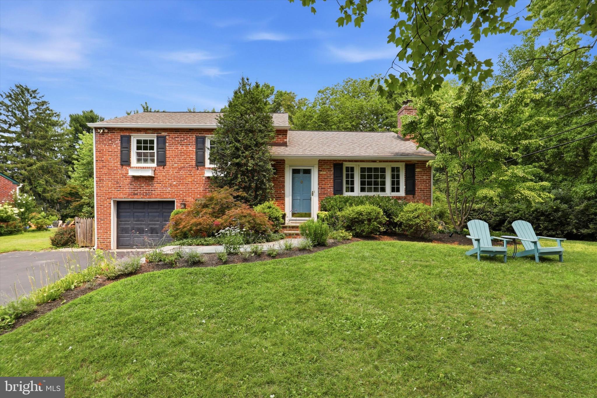 Welcome to 303 Landsende Road, a 1955 light and bright brick split that delivers far more space than meets the eye, all set on a beautifully landscaped, .30ac level lot. Located in the vibrant town of Devon, this home is part of the outstanding, Award-Winning T/E School District. The curb appeal stands out the moment you pull up, with mature plants, window boxes, and an extra-wide driveway leading to a 1-car garage. All of this on a quiet, tree-lined street where walking the neighborhood is a daily activity.Inside, original hardwood floors run through the main level and extend beneath the carpeting upstairs. The welcoming foyer opens into a bright, spacious living room centered around a wood-burning fireplace, which flows naturally into the light-filled dining room. Toward the back of the home, the updated kitchen features granite countertops, stainless steel appliances, gas cooking, and tile flooring. The kitchen looks out over the spectacular level backyard, including a bluestone patio. The upstairs has a well-sized primary bedroom with an en suite half bath. There are two other spacious bedrooms. The full hall bath has a classic black-and-white tile floor and a tub/shower. There are spacious closets and storage throughout this home. The home’s multi-level layout adds fantastic functional space. Just a few steps down from the kitchen is a versatile living area, which works well as an office, with bamboo flooring. Next to that is a large laundry and mudroom with a door going directly to the patio & rear yard.  The mudroom also has an inside entrance to the garage. Down a few steps, a massive finished family room provides the perfect spot for movie nights and play space. Off of the family room is a sizable unfinished storage room complete with built-in shelving.Outside, enjoy the spacious, flat,  fenced-in rear yard and bluestone patio. This move-in ready home offers incredible potential for future expansion. Perfectly located very close to Devon Yards shopping and dining, the Devon train station, Whole Foods,  and Valley Forge National Historical Park make local outings easy.  The home is part of a very welcoming neighborhood known for its fun activities  ( Halloween parade, game nights, and more )!  The location is perfect for an effortless commute, with major transit routes ( Rt 202, Rt76, PA Turnpike ) very close. A commute to Center City, Philadelphia, is simple by train or car.   Welcome home to this very special home and neighborhood!