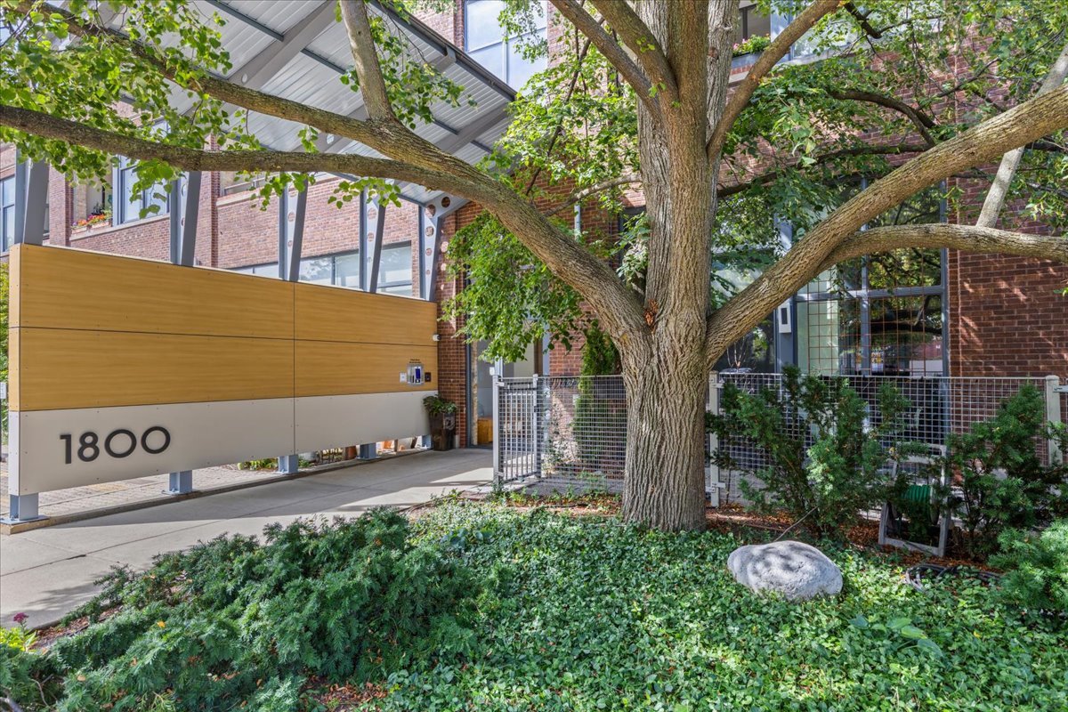 Here is a cool one sports fans...this very bright and simply fab two bedroom/two bathroom condo in Evanston's premier loft building epitomizes urban sophistication & style...just steps to all that downtown Evanston has to offer. Tucked away in the quietest location in the building, this first floor gem lives large with a huge private patio space at your door step. Brick walls, huge windows (all with floor to ceiling custom blind systems) and soaring concrete ceilings make this unit extra special. Sleek kitchen with high-end appliances, imported Italian cabinetry and huge island opens to spacious great room with gas fireplace. Loft bedroom with full bathroom also works as office or cozy den...currently open but easil enclosed. Additional features include: floating stairs to the loft, Bamboo wood floors, custom closets & in-unit laundry. Professionally managed HOA with strong reserves. Monthly assessment is a very reasonable $452 with taxes of $11,000....truly affordable in today's market when you consider like kind alternatives. Storage, bike room, and parking space #44 included and owners can rent their units. Not one to sleep on!