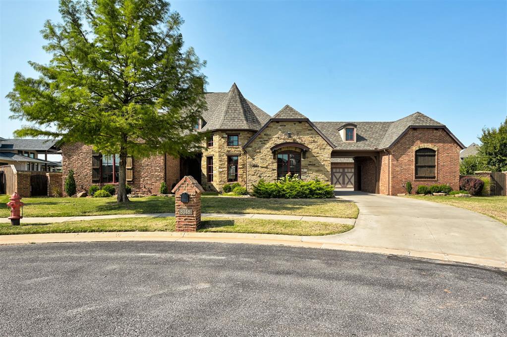 Welcome to your dream home in the gated community of Cobblestone Park. Perfectly positioned at the end of a quiet cul-de-sac, this property offers rare privacy paired with beautiful lake views that set the scene the moment you arrive. The exterior impresses with custom rock and brick details, a recently replaced Class 4 Grand Manor roof, and a welcoming portico with a friend's entrance and additional private parking.

Inside, every detail has been thoughtfully designed with quality in mind. Hand-scraped hardwood floors, natural stone accents, and custom cabinetry built on site create warmth and elegance throughout. The spacious kitchen is a true centerpiece with a large island, granite countertops in every room, and abundant storage, making it perfect for entertaining or everyday living. The grand master suite features its own private workout room, a spa-style bath with jacuzzi tub and walk-in shower, and an oversized custom closet with built-ins. A large second bedroom, private office with library, and a cozy room for the family that add both function and charm.

Upstairs, you’ll find a framed and wired 500 sq. ft. bonus space ready to finish, offering endless possibilities for a game room, studio, or guest retreat. When it’s time to relax, step outside to your backyard oasis complete with an 18,000-gallon saltwater diving pool, private pool bath, professional landscaping, and a fully fenced yard designed for both fun and privacy.

With modern comforts like foam insulation, tankless hot water, a storm shelter for eight, sprinkler and alarm systems, plus quick access to the Turnpike, this home offers the perfect balance of luxury, convenience, and peace of mind. It’s more than a home—it’s a lifestyle in one of the most desirable neighborhoods in the area.