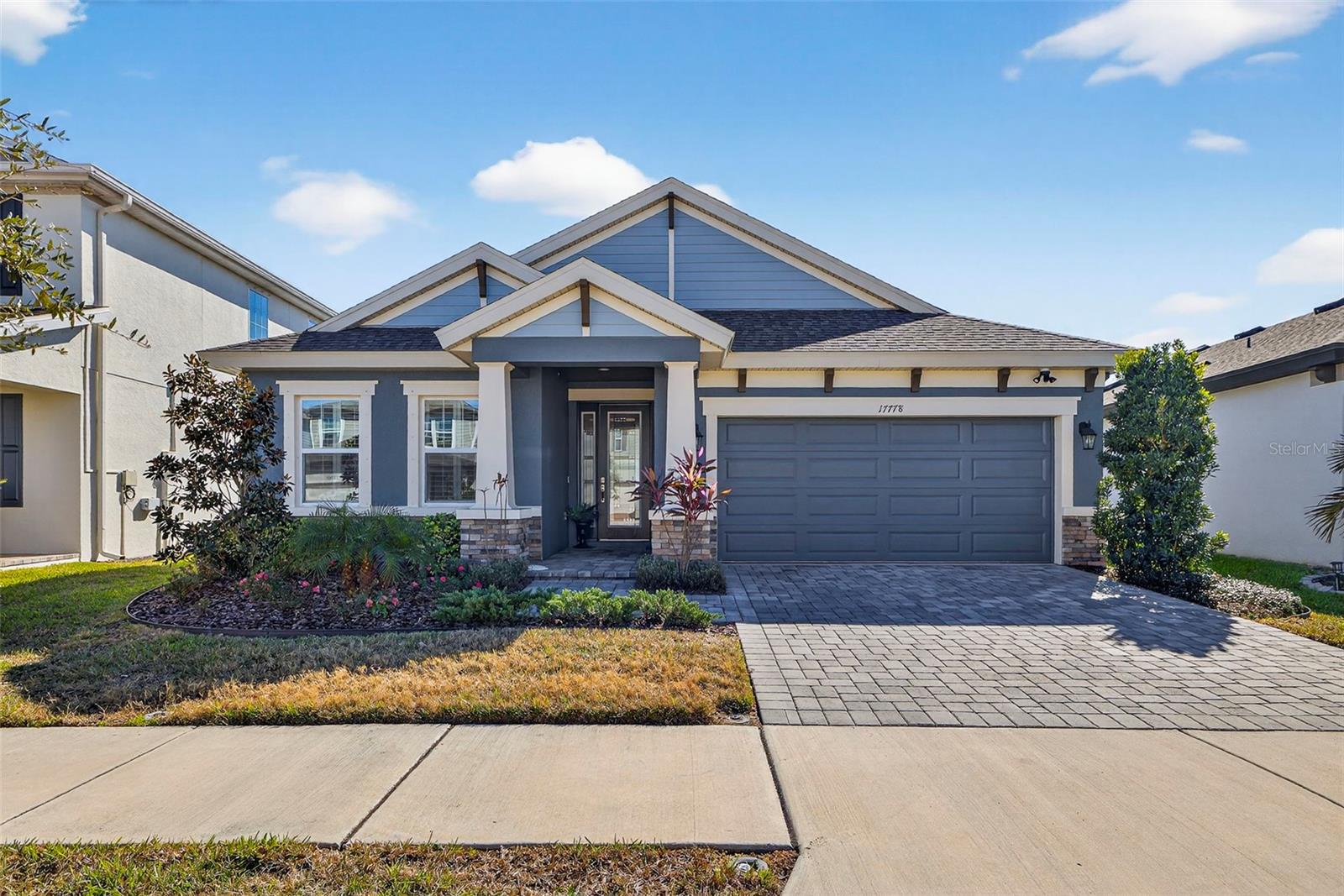 Welcome to this move-in ready 2023-built home located in the highly sought-after Bexley community, offering modern design, functional living spaces, and peaceful pond views. This thoughtfully designed 3 Bedroom, 3 Bathroom, 2-Car Garage split floor plan residence with a dedicated office/den offers stylish finishes and flexible living spaces throughout.Upon entering, you are greeted by a bright and inviting foyer that leads past a secondary bedroom and a versatile den that can easily function as a home office, guest space, or potential 4th bedroom. The home opens into a spacious, light-filled living area where the kitchen, dining, and family rooms flow seamlessly together, enhanced by four oversized sliding glass doors that create effortless indoor-outdoor living.The gourmet kitchen is designed for both everyday living and entertaining, featuring a large center island with bar seating, upgraded quartz countertops, top-of-the-line stainless steel appliances, a statement range hood, abundant cabinetry, and a walk-in pantry providing exceptional storage. Luxury vinyl flooring runs throughout the main living areas, complemented by plantation shutters in almost every room and updated light fixtures that add a polished finish. The home is equipped with smart features including a smart thermostat, Ring security cameras at the front door, garage, and rear exterior, and a reverse osmosis water system.The primary suite offers a spacious private retreat complete with dual custom closets and an en suite bath featuring double vanities, a walk-in frameless shower, linen closet, and a separate water closet. Each bedroom includes custom closet systems for added organization and functionality. The 3rd bedroom offers its own private ensuite bathroom, ideal for guest accommodations or multigenerational living. A dedicated laundry room includes cabinetry for additional storage along with the washer and dryer, and the two-car garage provides added space for storage or recreational gear.Outdoor living is just as inviting with an expansive panoramic screened lanai overlooking serene pond views, creating a comfortable setting for relaxing or entertaining, while the fully fenced and beautifully landscaped yard enhances privacy and outdoor enjoyment. Bexley offers a vibrant, master-planned lifestyle with resort-style pools, the Twisted Sprocket Café, miles of scenic walking and biking trails, neighborhood parks, dog parks, fitness centers, and year-round community events, all conveniently located near shopping, dining, and everyday conveniences.