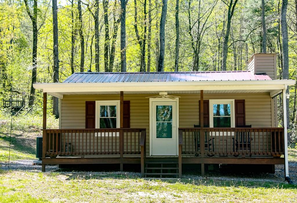 BACK ON THE MARKET NOT BY FAULT OF THE PROPERTY AND OFFERING A SECOND CHANCE TO YOU!  WASHINGTON COUNTY RETREAT! Vacation get away or full time residence.This fully renovated 595sqft cabin comes with everything you need.Beautiful kitchen with modern appliances, GE profile washer/dryer combo, & wall mount TV with high speed internet. Delicious well water with UV lamp and filter. Bathroom with walk-in shower. 10X16 workshop with electrical, 2 lofts, workbench & peg board. Heat pump, propane wall, encapsulated crawl space with dehumidifier. The back porch could easily be constructed to make a large master bedroom. Nestled in the beautiful Appalachian mountains, this 1 acre wooded plot has a beautiful flowing stream out back.  Plenty of space to start a small homestead, hunt, or just relax by the bonfire. Sip your coffee on the front porch and enjoy the sound of the flowing stream and watch the wildlife.  15-20 minutes to Chilhowie. Close to Mount Rogers, White Top, Damascus, Creeper Trail & more. Make this little piece of paradise yours! ONLY SELLING DUE TO HEALTH REASONS.