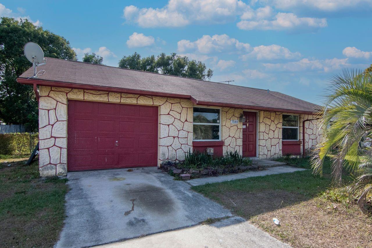 Investor Alert! Charming 2BR/1BA/1-car garage home in the quiet Seven Springs area of New Port Richey. Features include fresh paint, new wood flooring, and a functional floor plan with a screened porch.The property offers a spacious yard with mature trees, ample parking, and a large backyard with covered patio.Centrally located near Tarpon Springs, Trinity, and Palm Harbor. Great investment opportunity with excellent rental potential!