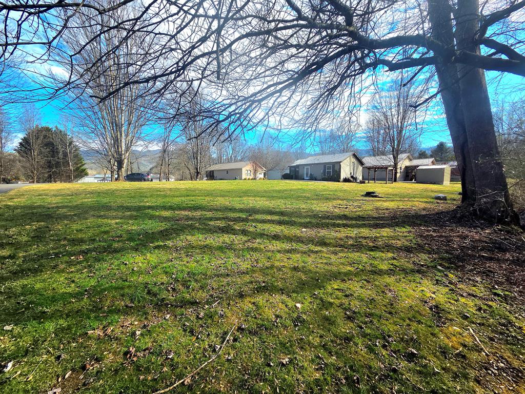 Nestled in Mountain Creek Village just outside the charming town of Andrews, NC, Lot 81 offers a rare opportunity to own a 0.19-acre homesite in the heart of a serene, well-maintained mountain community. Centrally located within the neighborhood, this lot sits directly across from the community gathering area, featuring a firepit, grill, and the soothing sounds of Junaluska Creek, creating a welcoming and social setting. A small creek along the rear of the property adds natural beauty, privacy, and a peaceful wooded backdrop. Enjoy year-round mountain views from the valley and the flexibility to build a cozy cabin or modern retreat with city water and sewer available, all while remaining outside city limits with no city taxes. The Lazy Bear Trail HOA maintains common areas, including mowing and weed-eating, and offers amenities such as a dog park and community space, all surrounded by attractive, well-kept homes. Located just 5 minutes from downtown Andrews, this property provides quick access to shopping, dining, and schools, while being approximately 20 minutes from the Nantahala River and Nantahala National Forest, offering world-class rafting, hiking, and outdoor recreation. Lot 81 is more than just land—it's an opportunity to enjoy a peaceful mountain lifestyle in a thoughtfully managed community. Buyer to verify all utilities and HOA regulations.