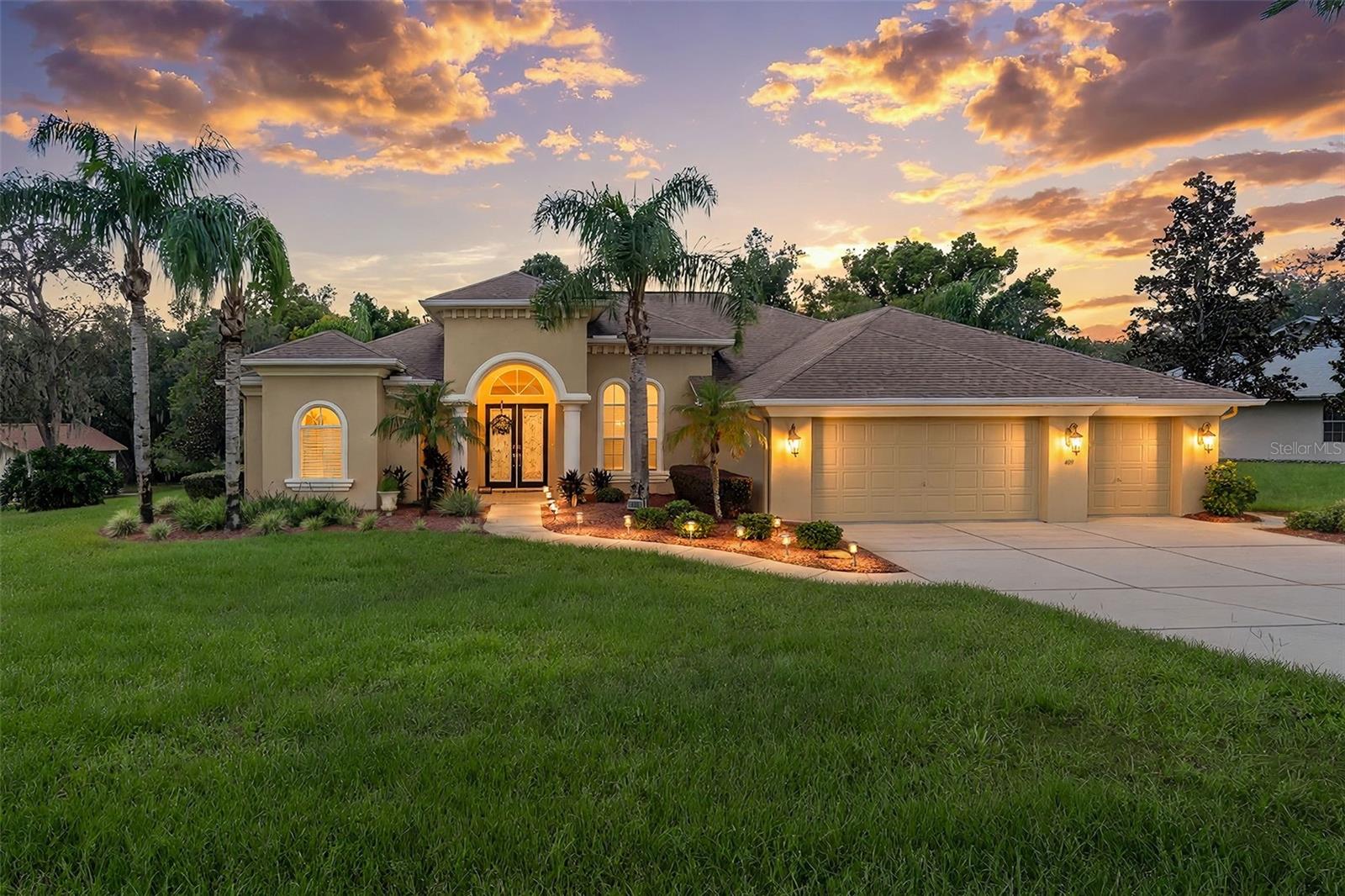 Luxury meets timeless elegance in this stunning custom-built pool home with  four-bedrooms, three bathrooms and a three car garage nestled on .60 acres with a lush, private backyard overlooking trees and woods. A brand new 30 year three dimensional shingle roof will be installed before closing and the buyer can choose the shingle color. The Highly Efficient Air Conditioner is only seven years old. Gorgeous pillars and exquisite architectural details set the stage for an impressive interior featuring beautiful travertine flooring, custom window treatments, and grand tray ceilings in the formal living and dining rooms. The beautifully appointed kitchen showcases an abundance of cabinetry, built-ins, stainless steel appliances, large walk-in pantry, wine refrigerator, recessed lighting, and gorgeous granite countertops. A breakfast bar accented with custom moldings and detailed woodwork opens to the spacious family room, where plantation shutters and elegant window treatments create a warm, inviting setting. The adjoining breakfast nook features french doors leading to the spectacular pool area. Designed for effortless indoor-outdoor entertaining, pocketing sliding doors open the formal living room to an expansive covered outdoor living area framed by elegant pillars. Enjoy the soothing waterfall cascading into the pool, a convenient outdoor kitchenette with a refrigerator and sink, and a pool bath with a step-in shower. French doors connect the primary suite to this beautiful retreat, while an additional guest bedroom offers sliding-door access to the pool. The spacious primary suite includes a charming sitting area and two generous closets. Its exquisite bathroom features a  garden tub, a beautiful chandelier, custom glass-block accents, a distinctive snail shower, and a large granite-topped vanity. Elegant moldings and architectural details enhance the space, while a private commode area includes built-in cabinetry with a granite countertop. All three guest bedrooms are beautiful and feature spacious walk-in closets. An oversized interior laundry room offers a washer, dryer, utility sink, and abundant cabinetry, while the impressive three-car garage provides ample room for vehicles and storage. The community of  East Linden Estates has a very low annual HOA ( $160/year ) and includes a playground, pergola and tennis and pickleball courts right within the community! This home is zoned for Springstead High School which is one of the only International Baccalaureate (IB) schools. Publix, shopping, dining, medical facilities and Weeki Wachee Springs, where you can enjoy kayaking, boating, swimming, and Florida's beautiful nature are close by. The  suncoast parkway ( Veterans parkway ) is just 8 minutes away, and Tampa International Airport is only 45 minutes south. With exceptional craftsmanship, gracious living spaces, and a tranquil wooded backdrop, this remarkable home offers luxury at its finest—priced to sell at just $554,900.