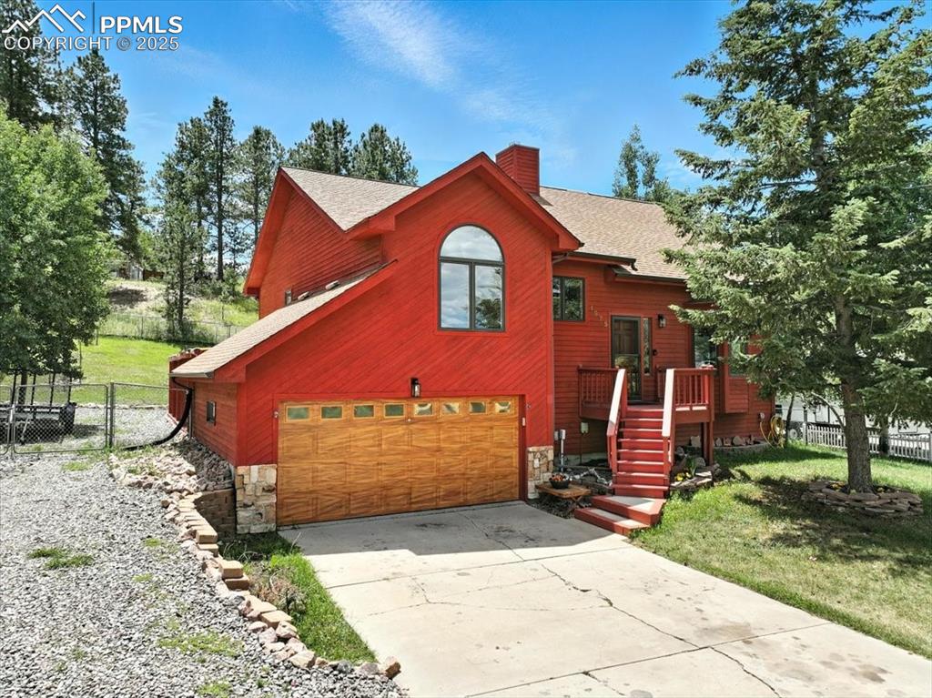 Check out the AMAZING mountain home! Tucked away in the hills of Woodland Park sits this beautifully taken care of home! Pulling up you notice the well manicured yard, additional RV Parking, E-V Charging outlets, and new garage door! Heading into the home you notice the beautiful natural wood flooring throughout the main level, custom wood blinds, and updated kitchen, all appliances are less than 2 years old! Heading up the few stairs to the additional office nook, and additional 2 bedrooms you can't help but notice how functional and spacious this home is! As you head up the stairs to the private masters suite you see the elevated ceilings, and custom wood barn doors! Expanding to the basement you cant help but see the endless potential, this space could be an additional bedroom, or has proven rental potential! You can walk out to the oversized garage with workshop, and also head down into the cellar space that houses additional storage and a potential additional workshop! When needing some mountain air you can enjoy the oversized wood porch with expandable awning, and fenced in backyard! This home has endless potential to be your comfy mountain escape! Enjoy!