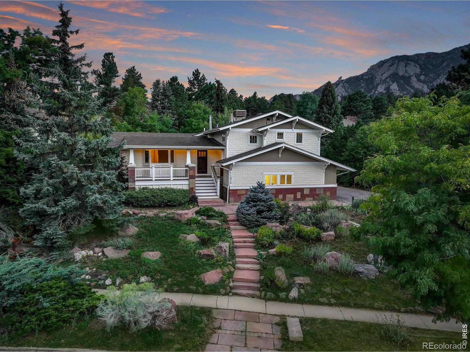 A rare sanctuary at the base of Shanahan Ridge, where the Flatirons rise in your backyard and endless open space unfolds at your door. Set quietly away from the road, this private retreat captures breathtaking panoramas of both city lights and striking Flatirons, delivering a sense of seclusion rarely found in such an enviable Boulder location. Inside, sophistication meets comfort. A formal living and dining room is crowned with a coffered ceiling, while rich wood flooring flows through sunlit spaces. The chef's kitchen takes center stage with Viking gas range, dual ovens, island with breakfast bar, pantry, and new premium appliances-all framed by mountain views. The family room, anchored by a moss rock fireplace, built-ins, and a charming window seat, invites gatherings that flow easily outdoors. Step onto the covered deck or the expansive wraparound paver patio, where the backyard seems to extend forever into open space. This is the property's heart-a serene, private setting that lives like your own endless sanctuary. Upstairs, the primary suite is a haven of light and luxury. Walls of windows frame "to-die-for" views, while new wool carpet and a Juliette balcony add warmth and romance. Indulge in the spa-like five-piece bath with radiant-heated floors, jetted soaking tub, and dual custom closets. Secondary bedrooms, each with California Closets, are equally refined. The lower level, refreshed with new carpet, offers additional living space with two bedrooms and endless versatility. With fresh interior and exterior paint, a new swamp cooler, and thoughtful upgrades throughout, this residence balances timeless elegance with modern comfort. More than a home, it is a lifestyle-secluded, sophisticated, and set against one of Boulder's most iconic backdrops.