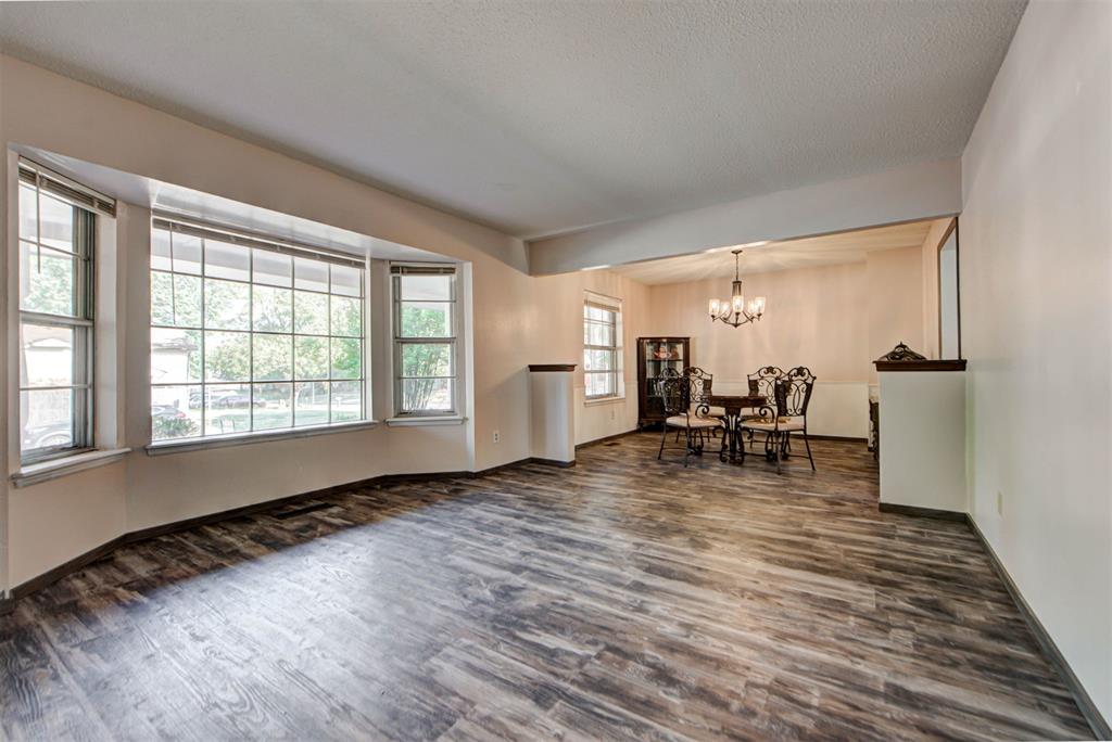 Warm, inviting, and easy to  feel right at home this two-story home has been thoughtfully refreshed and is ready for its next chapter. Upon entry you are greeted to two inviting living areas, perfect for game nights, gatherings, or cozy evenings by the wood-burning fireplace. The kitchen sits near the breakfast nook and the designated dining room, creating a natural flow for holiday gathering or weeknight dinners. Upstairs you'll find all four bedrooms, keeping everyone together but with plenty of space to spread out.  The downstairs bathroom has been fully updated with a contemporary washbowl sink for a clean design, while upstairs you will find two full baths filled with natural light. Added attic insulation keeps things efficient, and for added peace of mind, a brand new HVAC system will be installed prior to closing! Fresh finishes flow throughout with updated luxury vinyl plank flooring that runs seamlessly upstairs and down, new interior doors with sleek French-handle hardware, updated trim, paint, and stylish touches that give the home a modern feel while keeping its warmth. The backyard is large and full of potential, offering space to garden, play, or simply relax. Plus, with a neighborhood park nearby outdoor fun is always close at hand. Located just 1.8 miles(or a quick 6-minute drive!) to OU Stadium, this home is rooted in charm, refreshed with care, and ready to welcome you home.