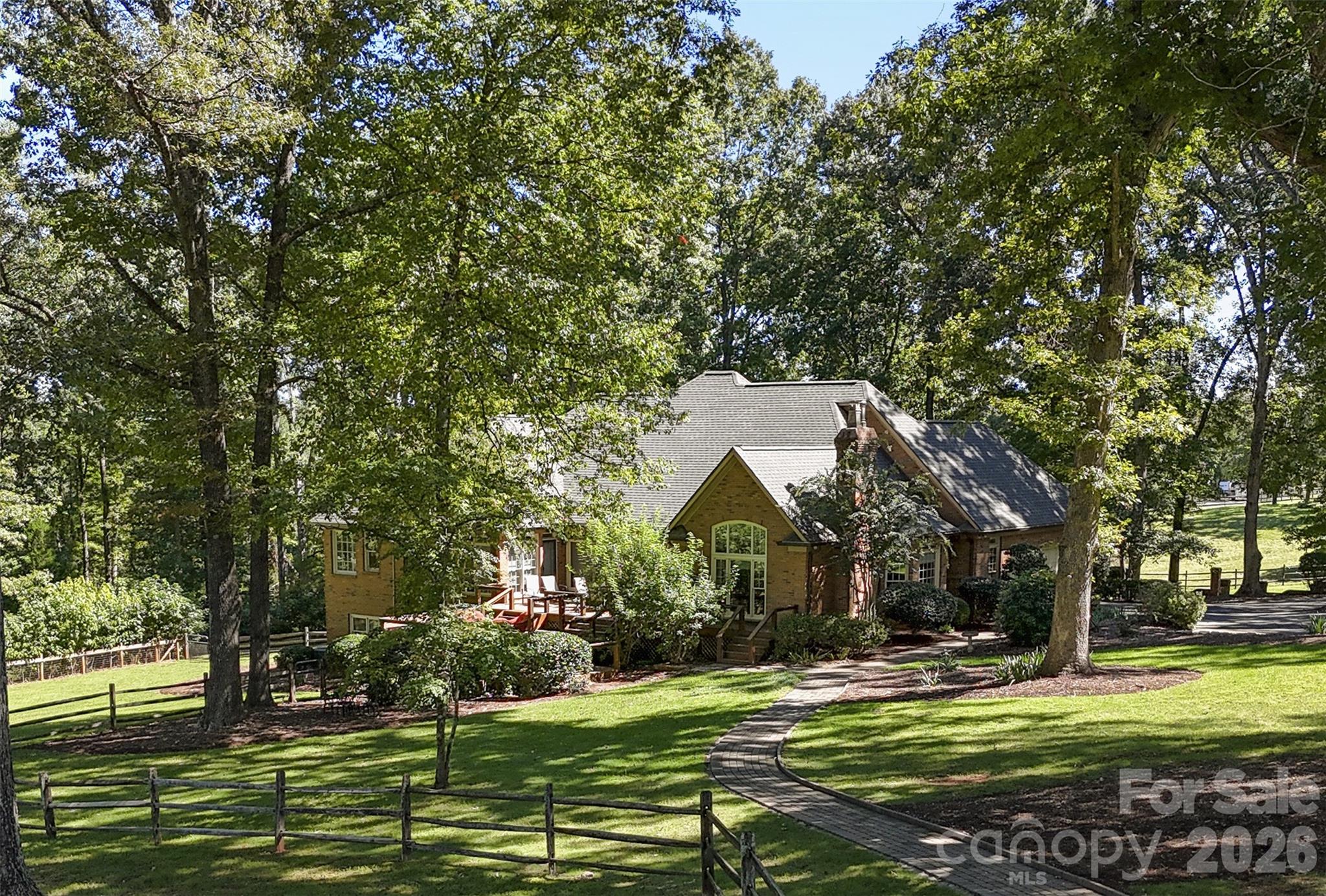 AUCTION: Live onsite and online bidding ends Saturday, November 14 at 12:00 PM. This stunning equestrian property conveys fully furnished. Sweeping mountain views on over 20 private acres in the heart of Tryon horse country. The property sits immediately adjacent to the CETA trail system, so you can ride straight from your own gate onto miles of trails, and it’s just 14 minutes to TIEC with no HOA. The 5,264 sq ft main residence has a main-level primary suite with a tray ceiling, sitting room, spa bath, and custom walk-in closet, plus a second en-suite bedroom and a study on the same floor. It also offers a vaulted dining room, a living room with 11' ceilings, a vaulted family room with fireplace, a kitchen with breakfast room, and a 495 sq ft deck facing the views. The finished walk-out lower level adds 3 bedrooms, 2 baths, a family/media room, and a recreation/billiard room with a bar. The center-aisle barn has 4 stalls, a wash stall, roll back roof on shavings storage, hay loft, a grooming area, tack, a heated workshop, and an equipment garage. Above the barn is a stunning ~1,690 sq ft apartment with a vaulted great room, balcony, kitchen, bedroom, and office, and an owner’s tack room/living quarters sits below it. The barn has 2 full baths. You’ll also find a 2-stall run-in shed, paddocks, and a wooded trail to a large private arena. The roof is new (2024), the HVAC dates to 2017, there are dual buried propane tanks, and multiple wells serve the property. This property is Move-in and Ride-in ready. Preview/open house Oct 31, 11 AM–2 PM. Pre-auction offers welcome. A 10% buyer’s premium applies: for example, a $1,900,000 bid plus $190,000 makes a total of $2,090,000. $25,000 deposit, 30-day closing, buyer pays all closing costs. Sold AS-IS, WHERE-IS, with no contingencies.