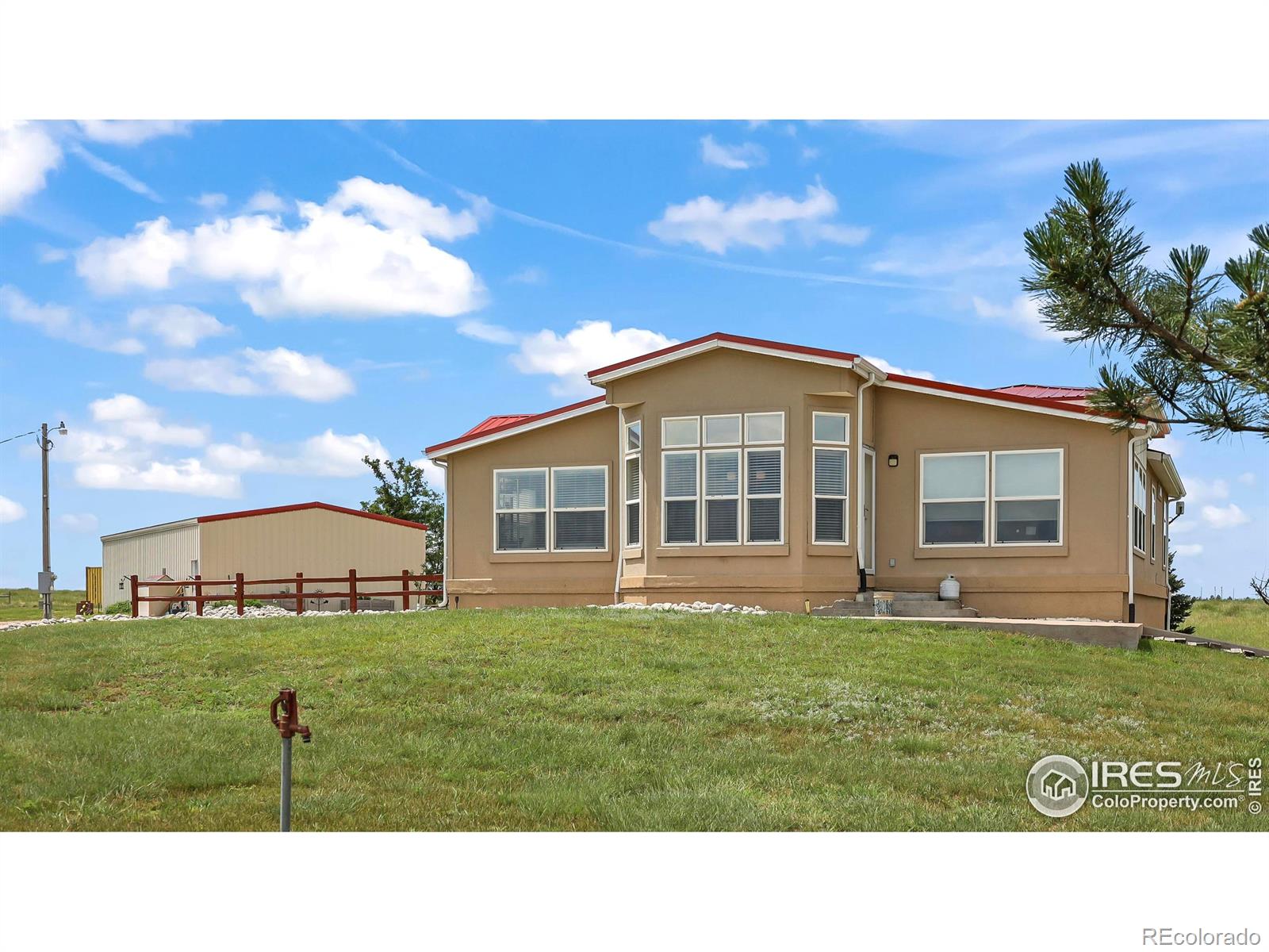SETTLE UP IN YOUR HOME ON THE RANGE! This beautiful 3,890 SqFt home sits on top of the hill of an 80 acre parcel, complete with a 30'x60' steel frame shop, fenced pasture, 5 working hydrants and mature windbreak. The 3 bed 4 bath features a full finished basement built to entertain around a custom wet bar, pool table, theater area, 2 walkout patio areas, huge 1/2 bath with shower rough-in and room for a refrigerator/freezer PLUS an office/4th non-confirming bedroom, new roof, newer flooring and appliances. Upstairs you'll find spacious main level amenities with a family room, living room, kitchen bar top & island, pantry, breakfast nook, formal dining room, built-in buffet, double door entry to the primary bedroom, newly updated luxury primary bathroom (soaking tub, tiled shower, double sinks, lighted mirrors), 1/2 bath off laundry, + two more bedrooms and full bath. The detached shop includes a 12' tall auto overhead door, 220v, shelving, concrete floors and air compressor. No HOA, only 33 minutes to Sterling & 17 minutes to Akron.