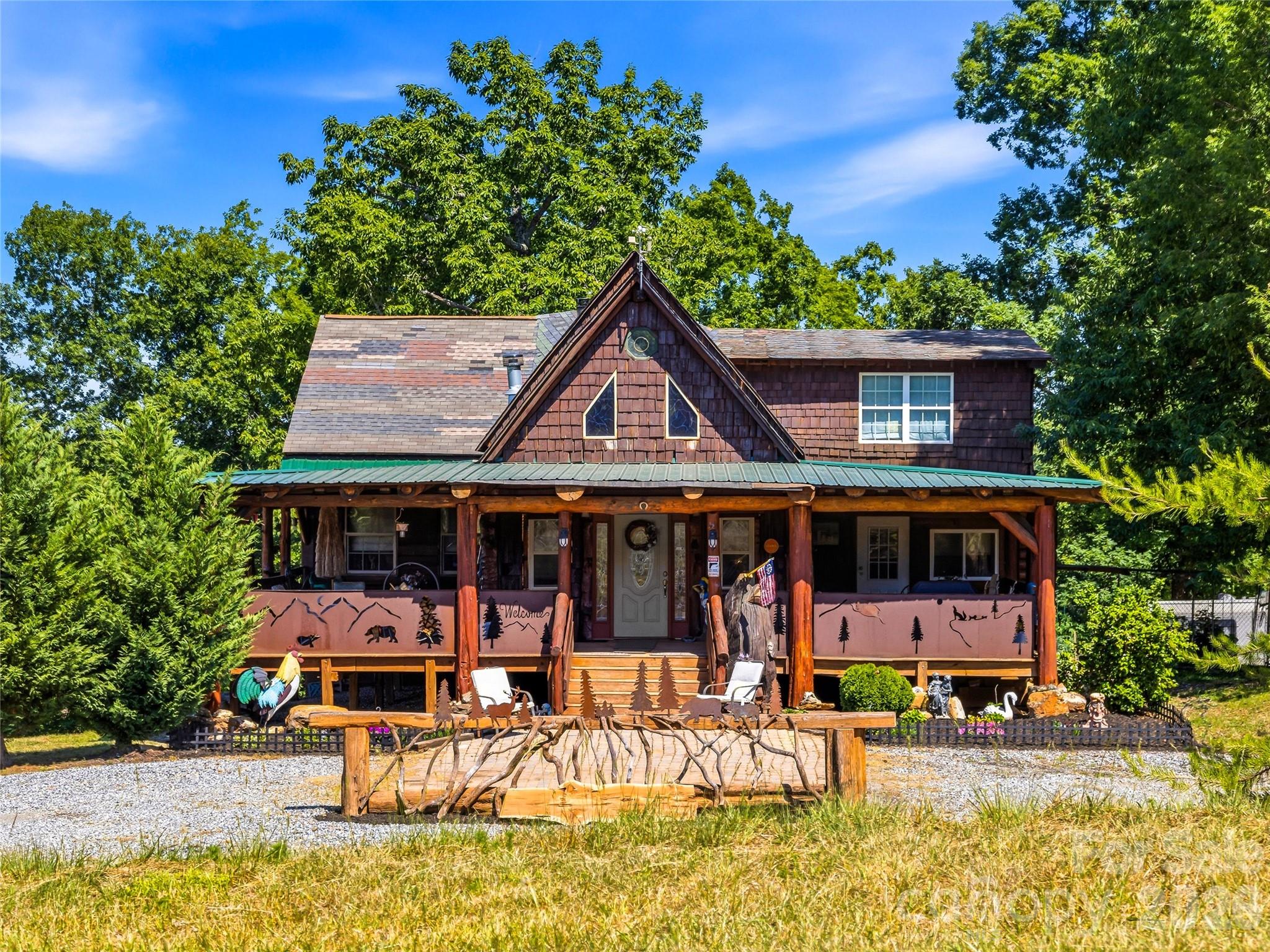 Few mountain properties offer the story, flexibility, and possibilities found on this 10-acre retreat  just minutes from downtown Rutherfordton, less than 20 miles from Lake Lure and Chimney Rock State Park, and about an hour from Asheville.  The custom-built 3-bedroom, 2.5-bath log cabin was handcrafted from timber milled directly from the property, creating a home rich in character with exposed wood beams, custom details, and thoughtfully designed living spaces.  In addition to the main home, the property includes a 2-bedroom, 1-bath guest cabin currently operating as a short-term rental, a second cabin under development, and multiple additional homesites—ideal for a family compound, retreat, or expanded rental opportunity. Enjoy a stocked fishing pond, peaceful waterfall with a meditation area, creek, gem mine replica, mountain views, and wooded privacy. The hangar provides a unique opportunity for aviation enthusiasts to store their aircraft, while equestrian buyers may envision converting the space into a barn to complement the property's proximity to the Tryon International Equestrian Center, located less than 10 miles away. Further down the property, you'll find far more than a typical garage: Moonshiner's Garage is a destination of its own—offering a vehicle lift, generous workshop space, and plenty of room for collectors, hobbyists, and automotive enthusiasts.  Whether you're looking for a mountain retreat, aviation property, income-producing investment, or legacy estate, 1002 C C Road is a rare opportunity unlike any other.